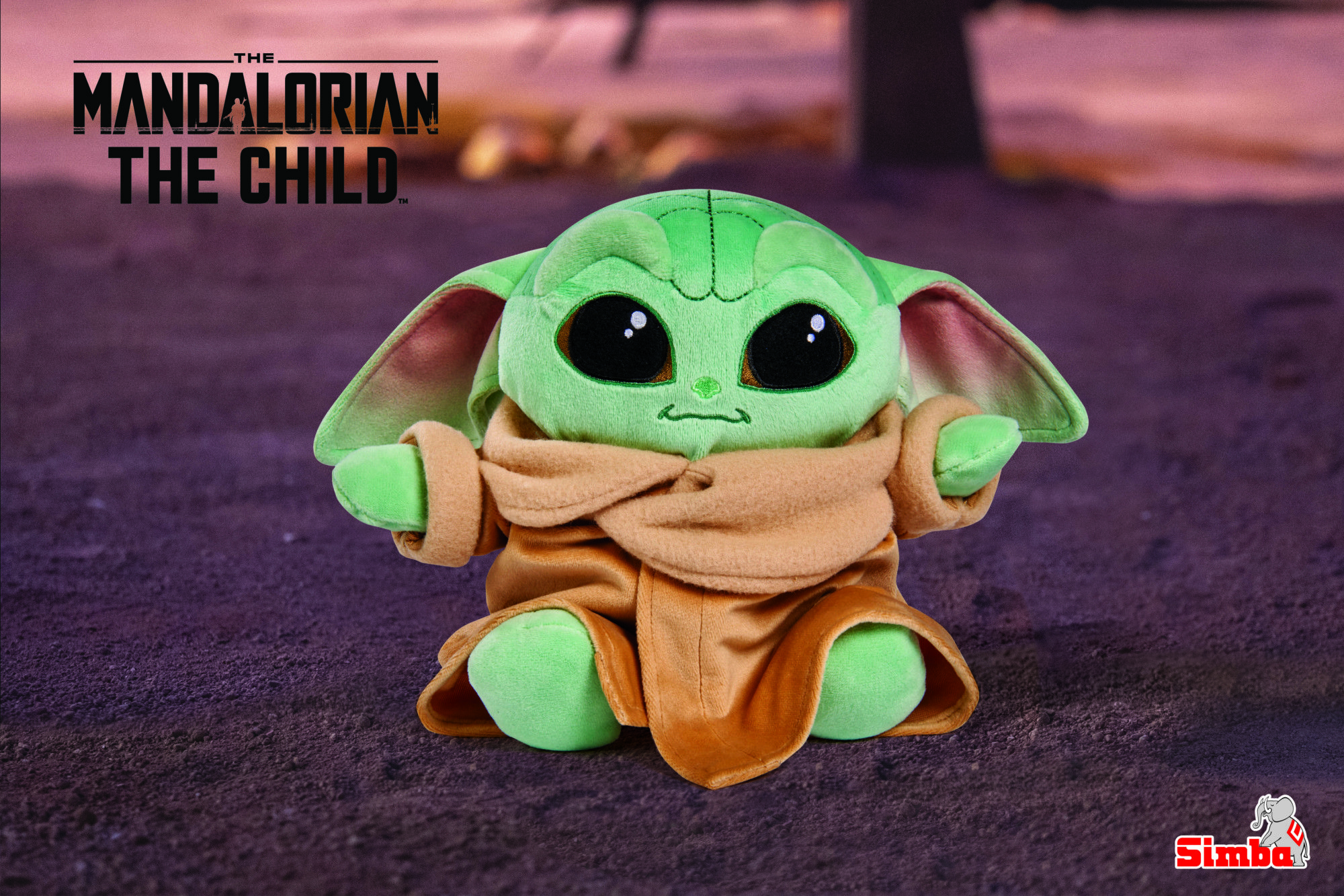 A plushie of The Child from The Mandalorian, a green alien with big eyes and a brown cloak, is sitting on the ground. - Baby Yoda