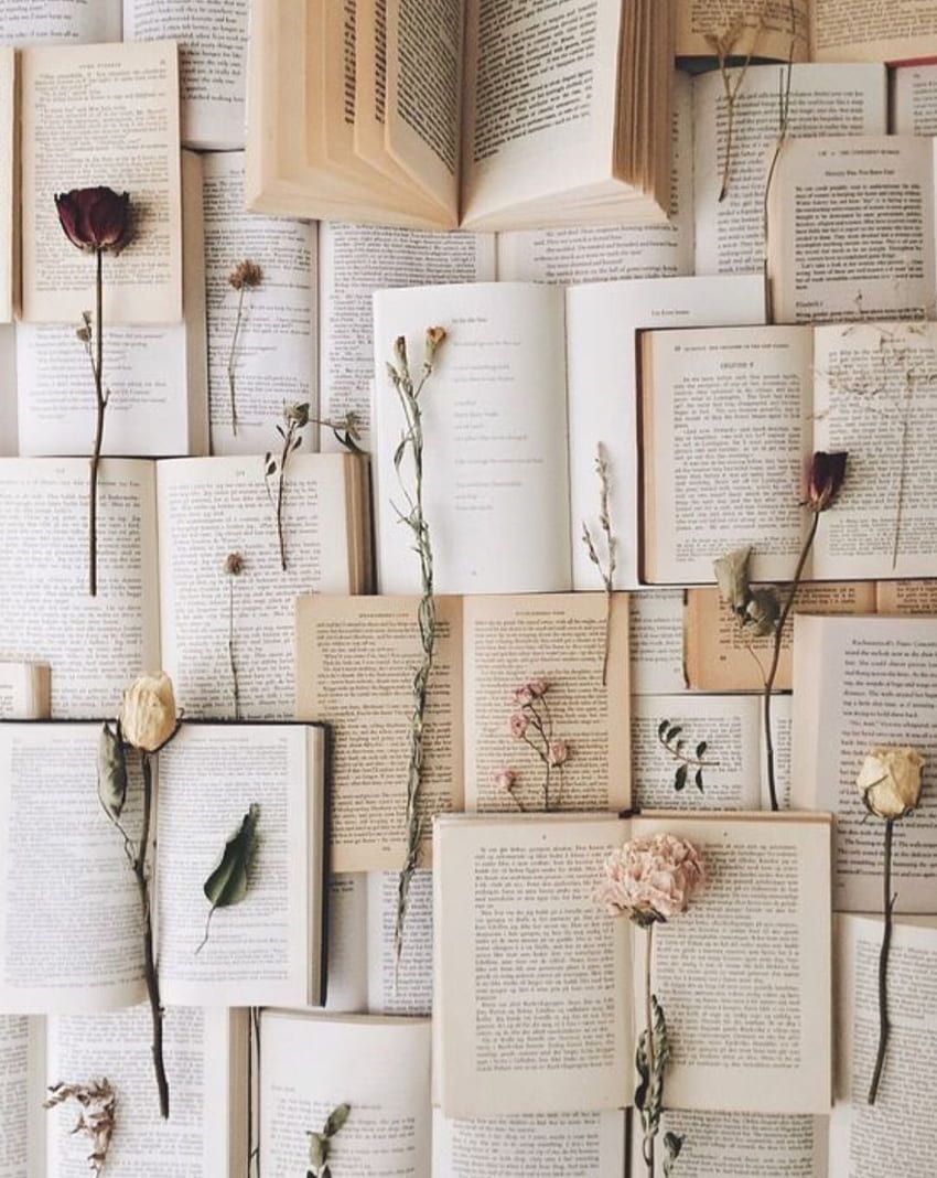 A bunch of books are arranged with flowers on them - Paper