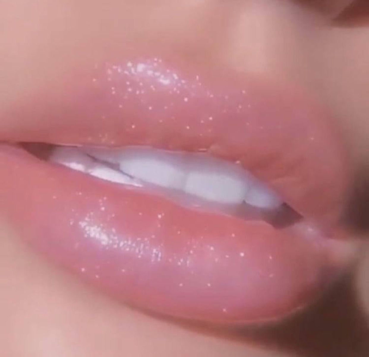 Close up of a woman's lips with a clear lip gloss - Lips