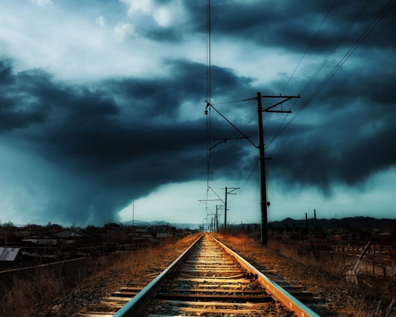 A storm approaches over a railroad track - 1280x1024