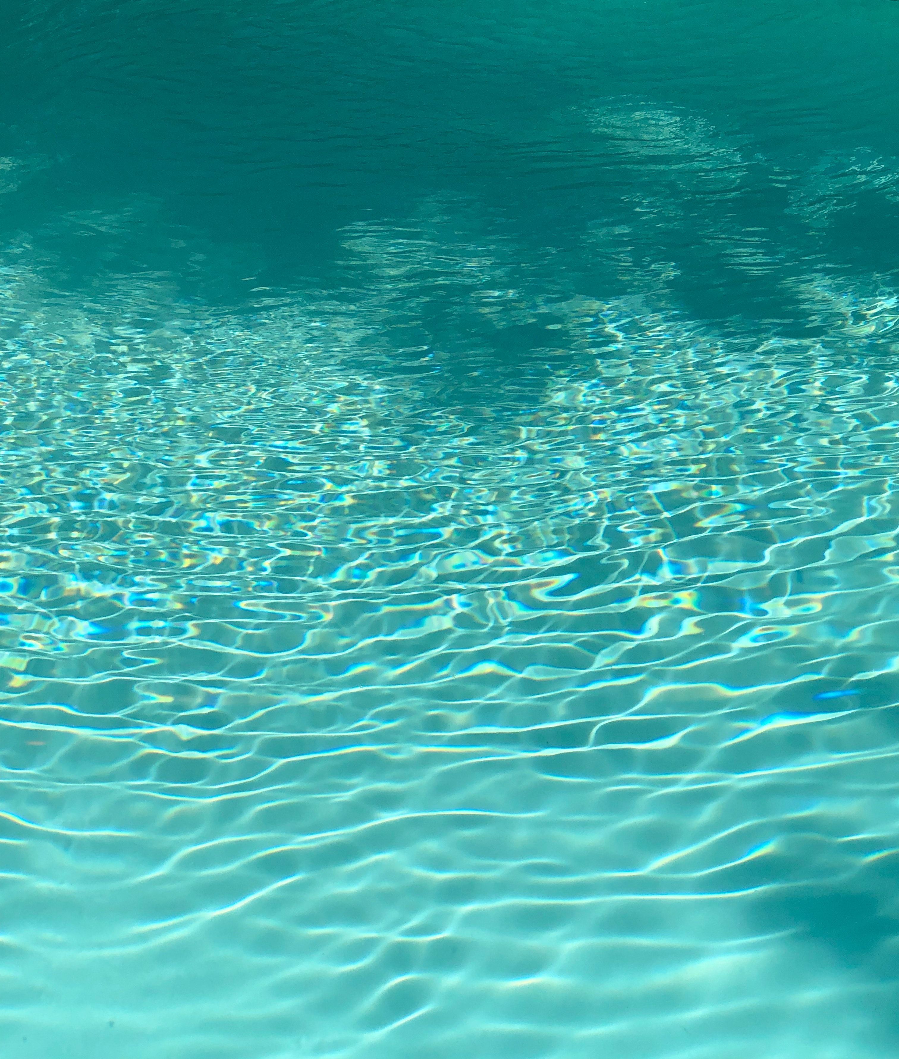 Underwater view of a pool with light reflecting off the surface - Swimming pool