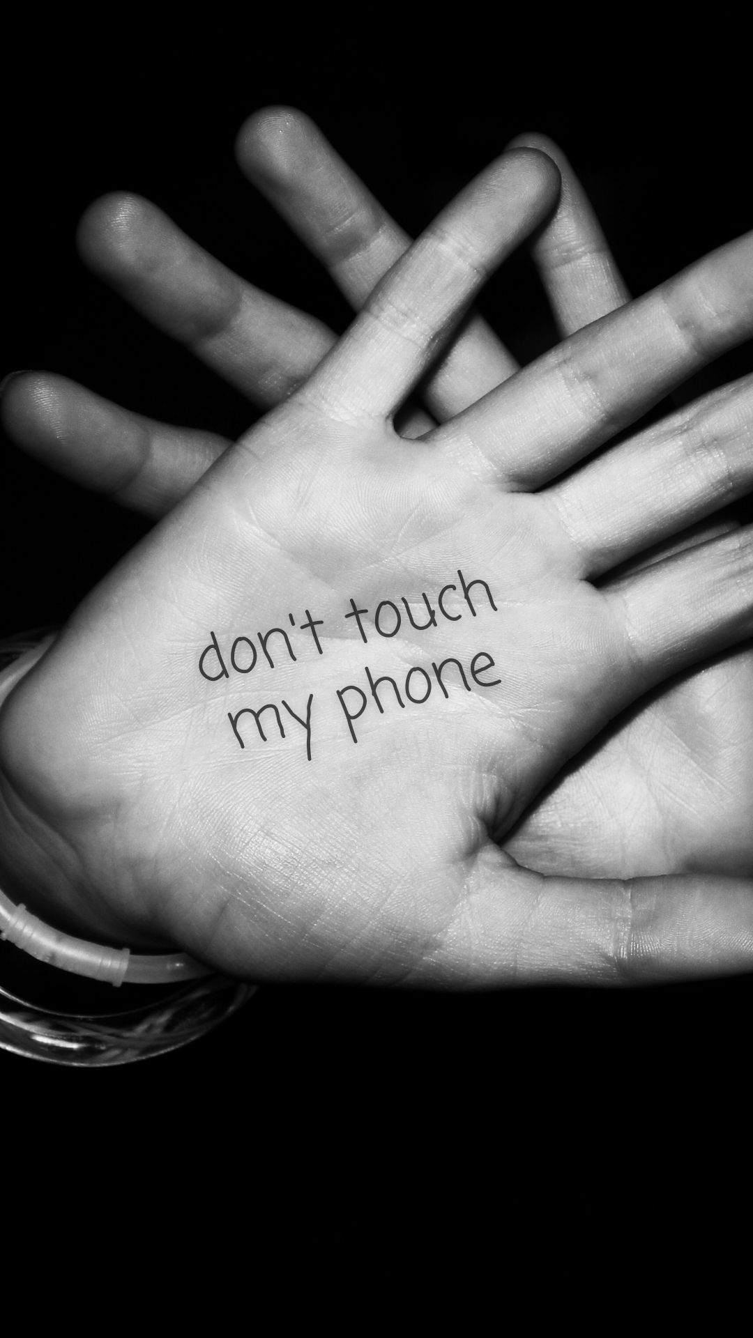 A person has their hands up with the words don't touch my phone written on them - Don't touch my phone