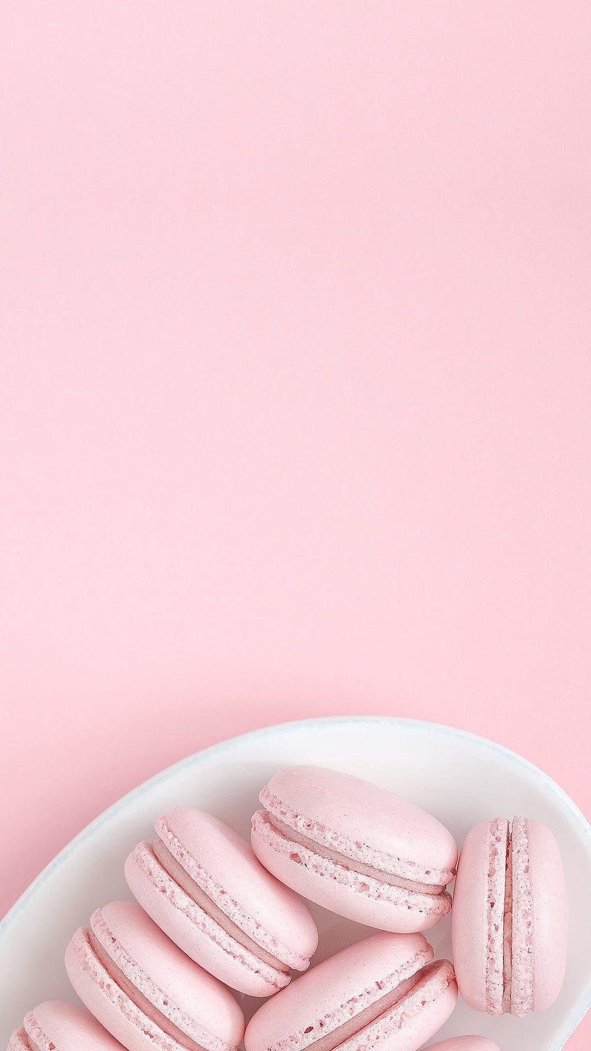 A plate of pink macaroons on top - Macarons