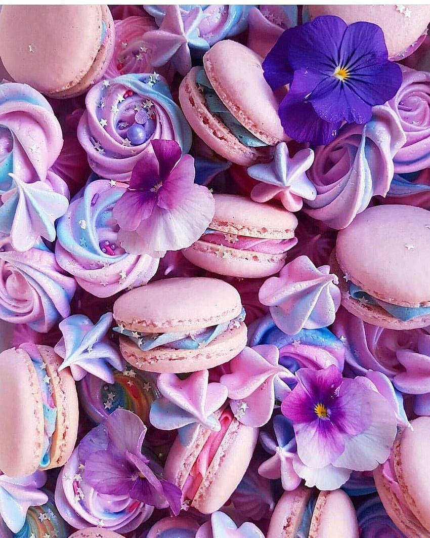 A pile of macarons with purple flowers - Macarons