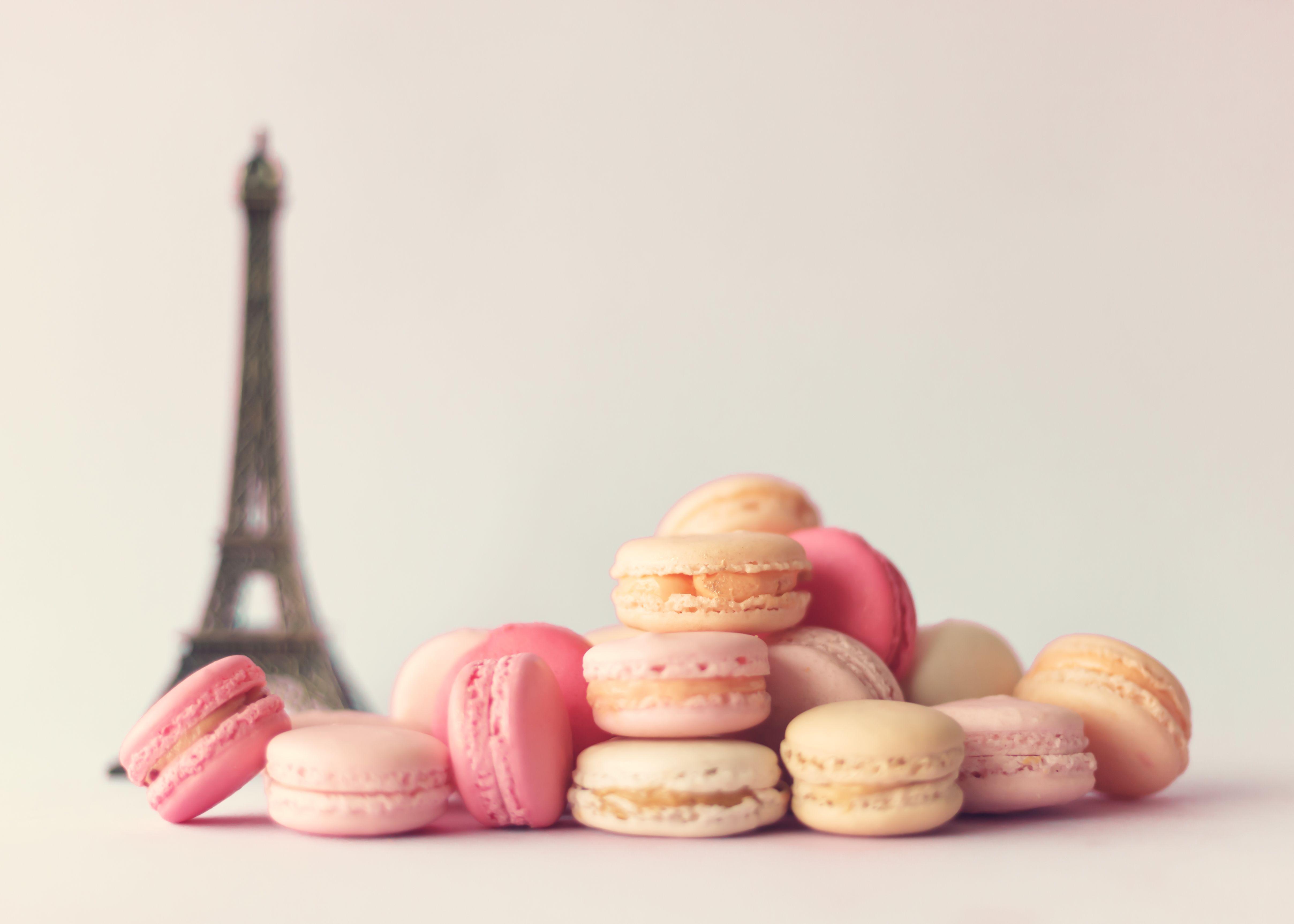 A pile of macaroons next to the eiffel tower - Macarons