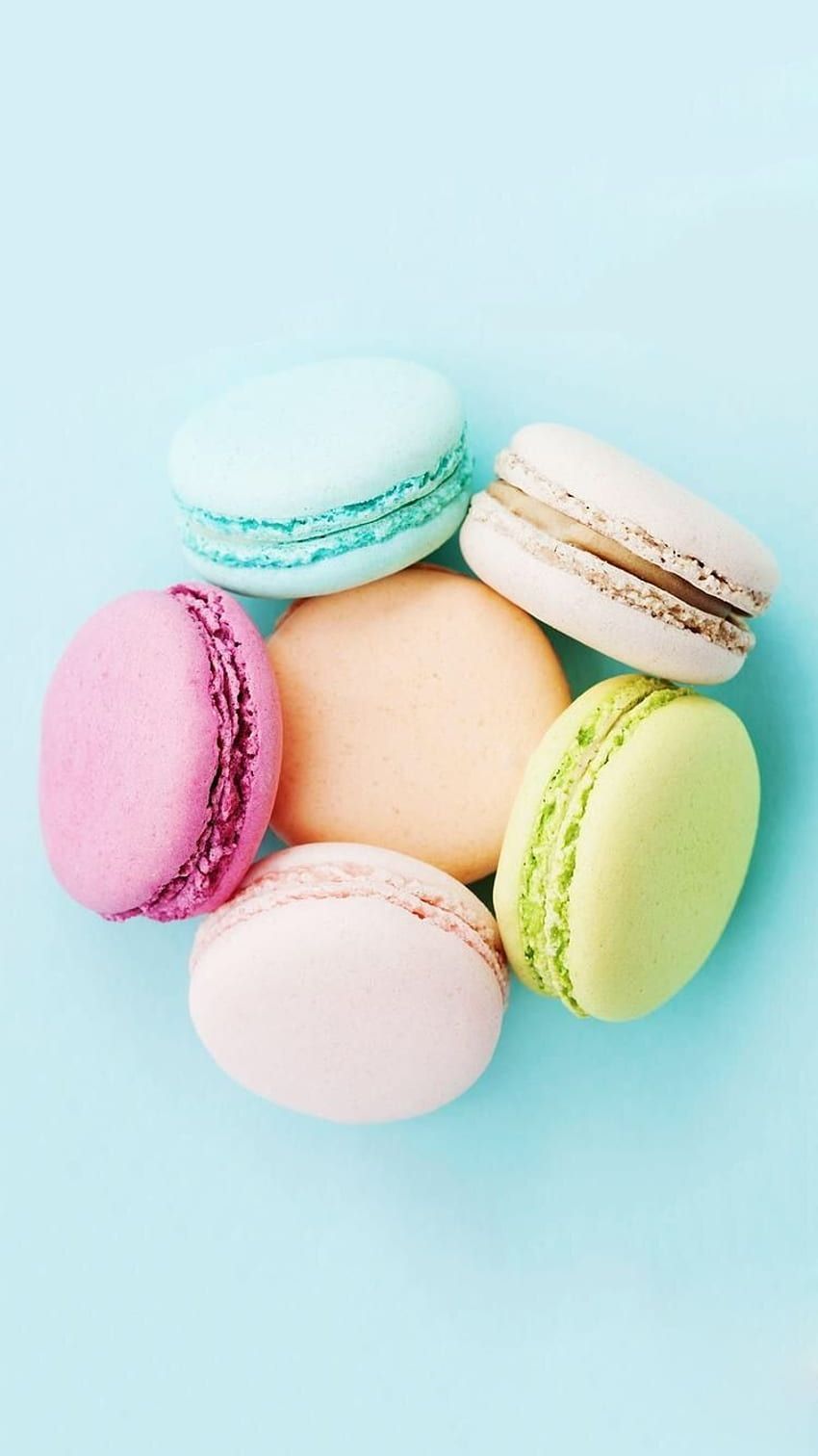 A collection of colorful macarons on a blue background - Macarons