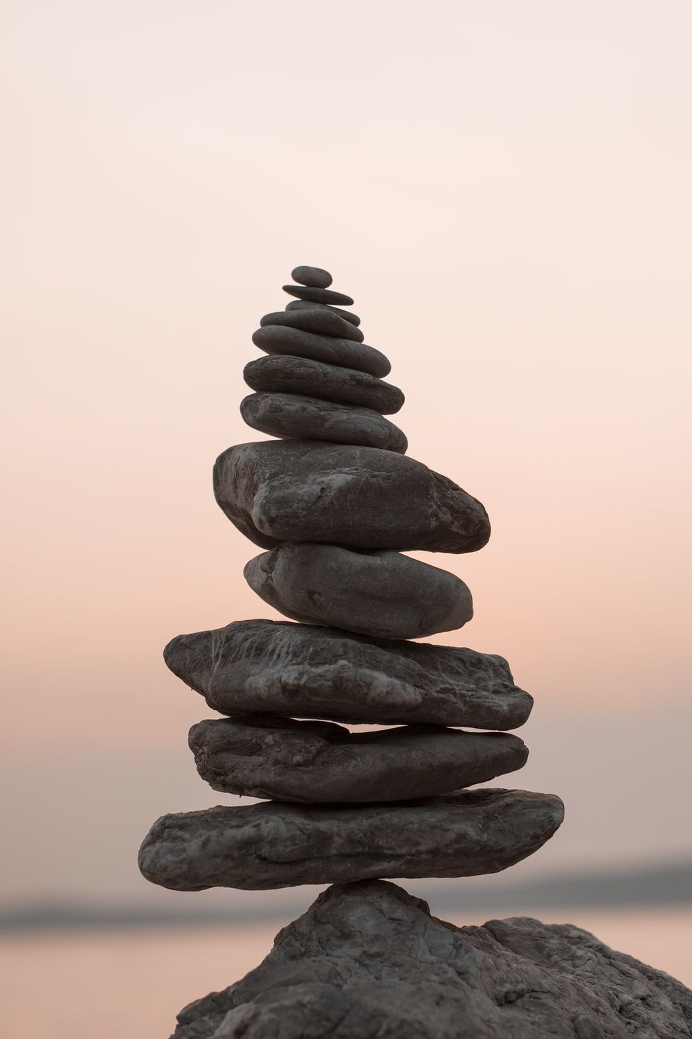 A stack of rocks in front of a sunset - Balance, rocks