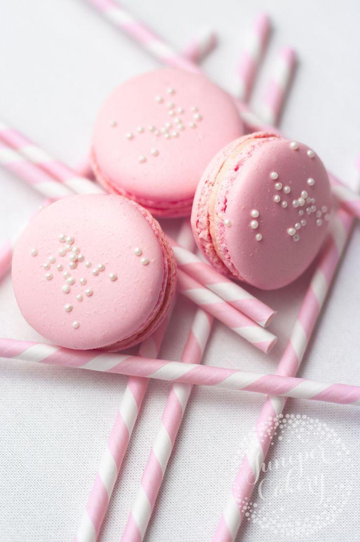 A close up of pink macarons and straws - Macarons