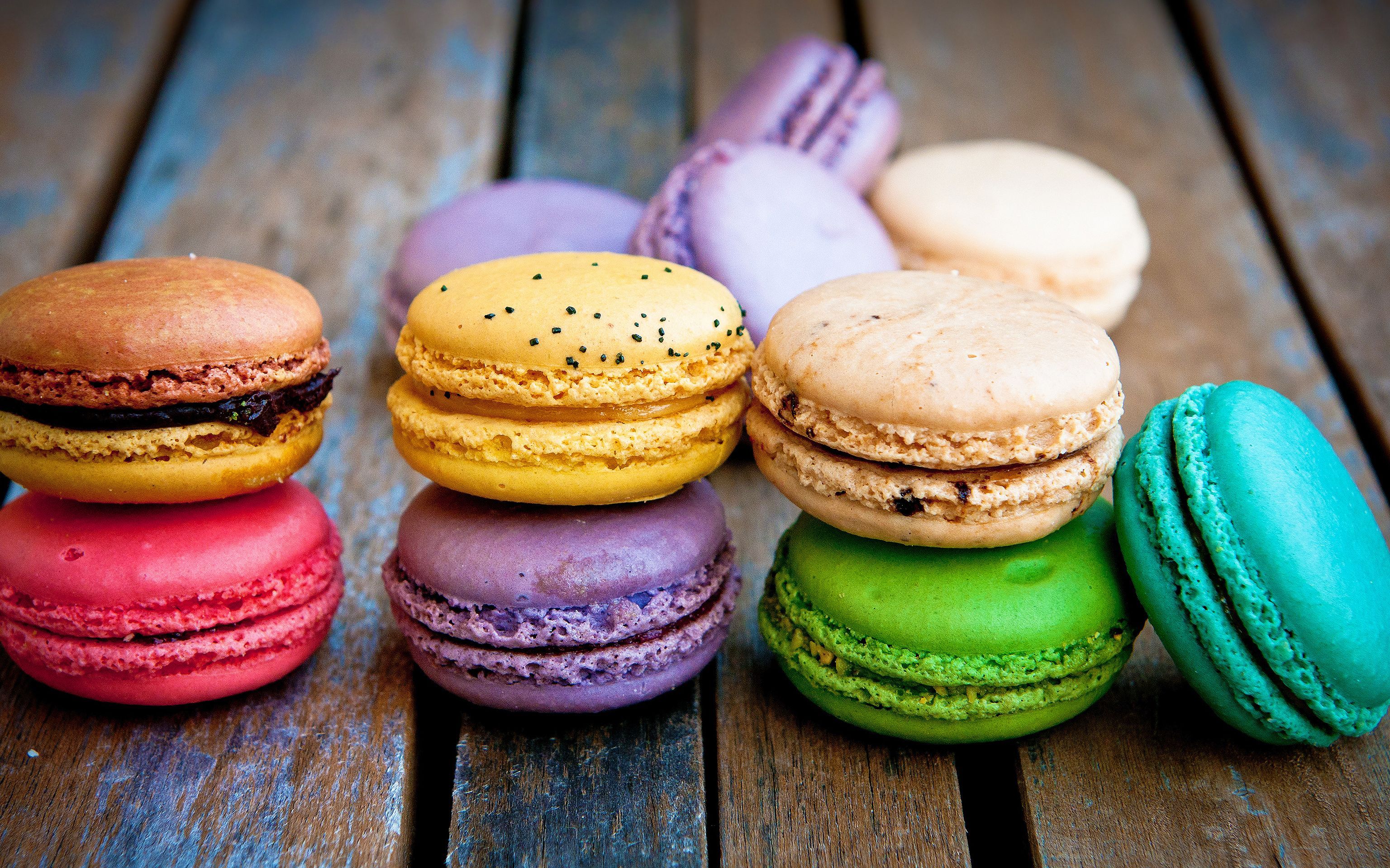 A photo of a table with colorful macarons on it. - Macarons