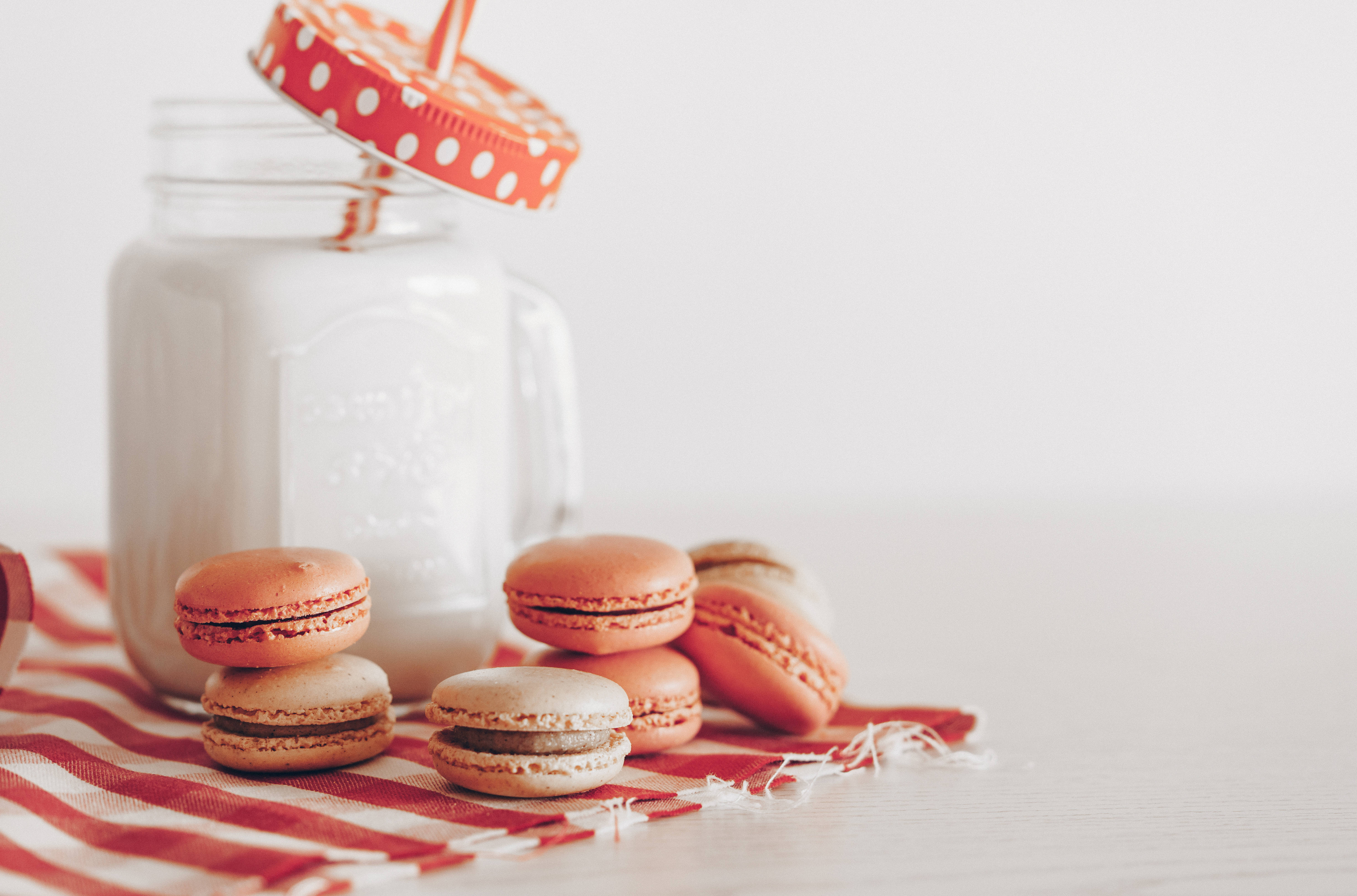 Macarons and a glass of milk on a table - Milk, macarons