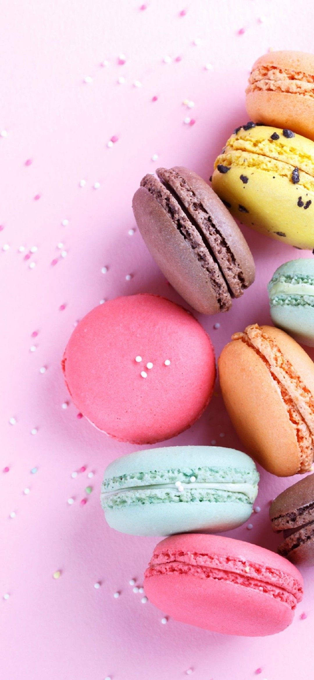 A group of colorful macaroons on pink background - Macarons