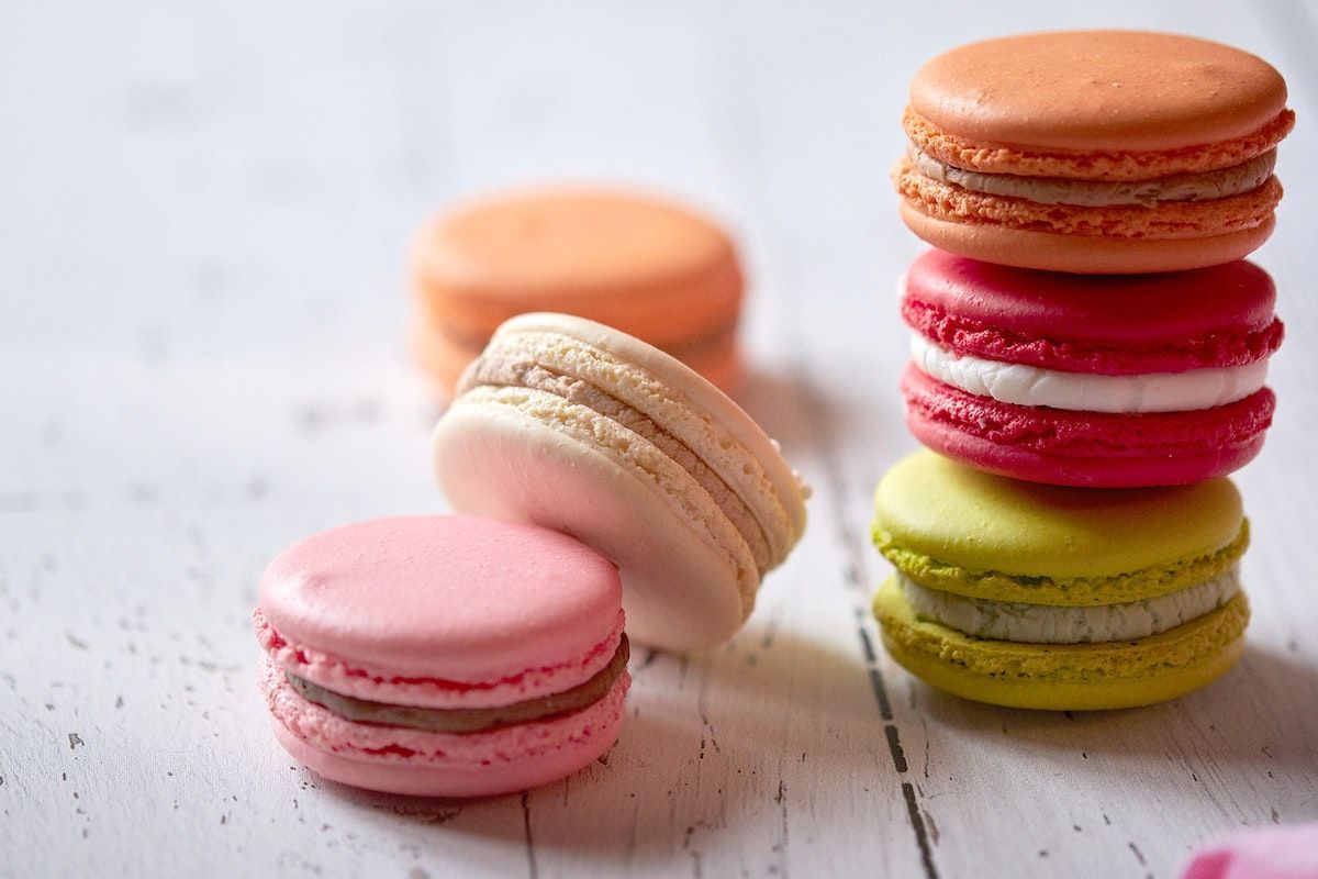 A stack of macarons with different colors and flavors - Macarons