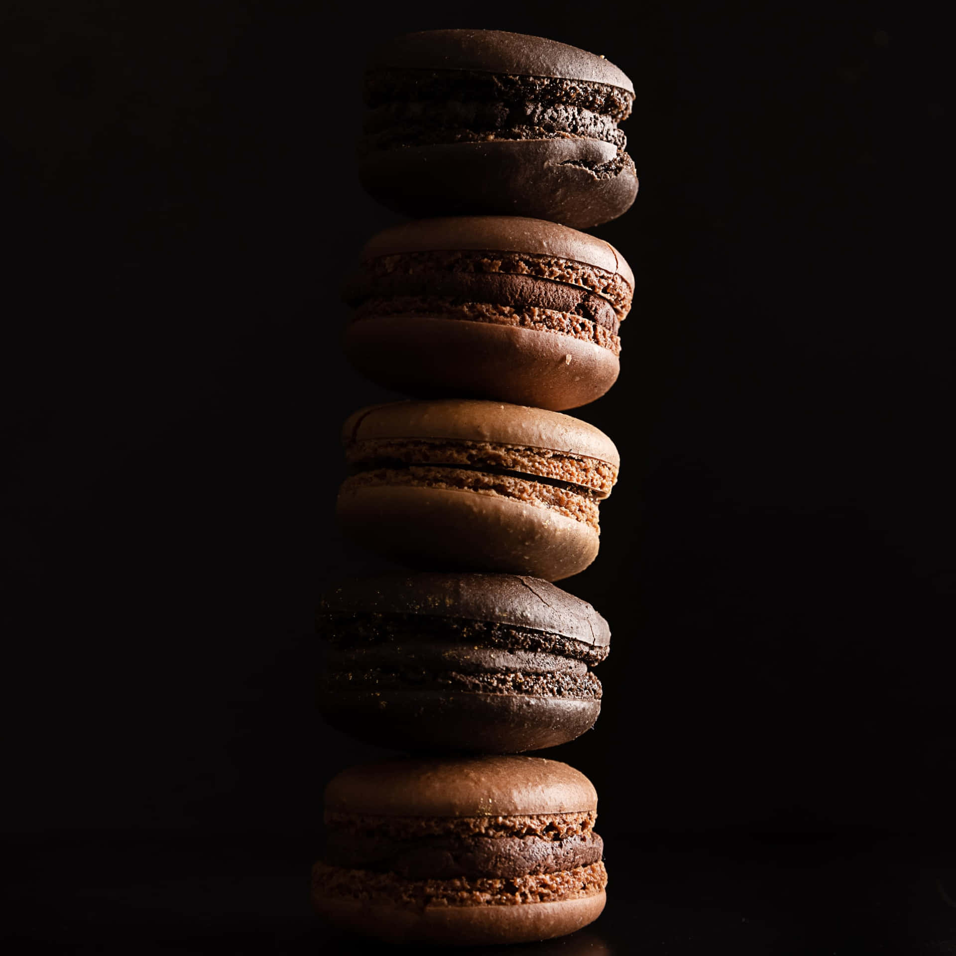 A stack of chocolate covered pastries on top - Macarons, chocolate