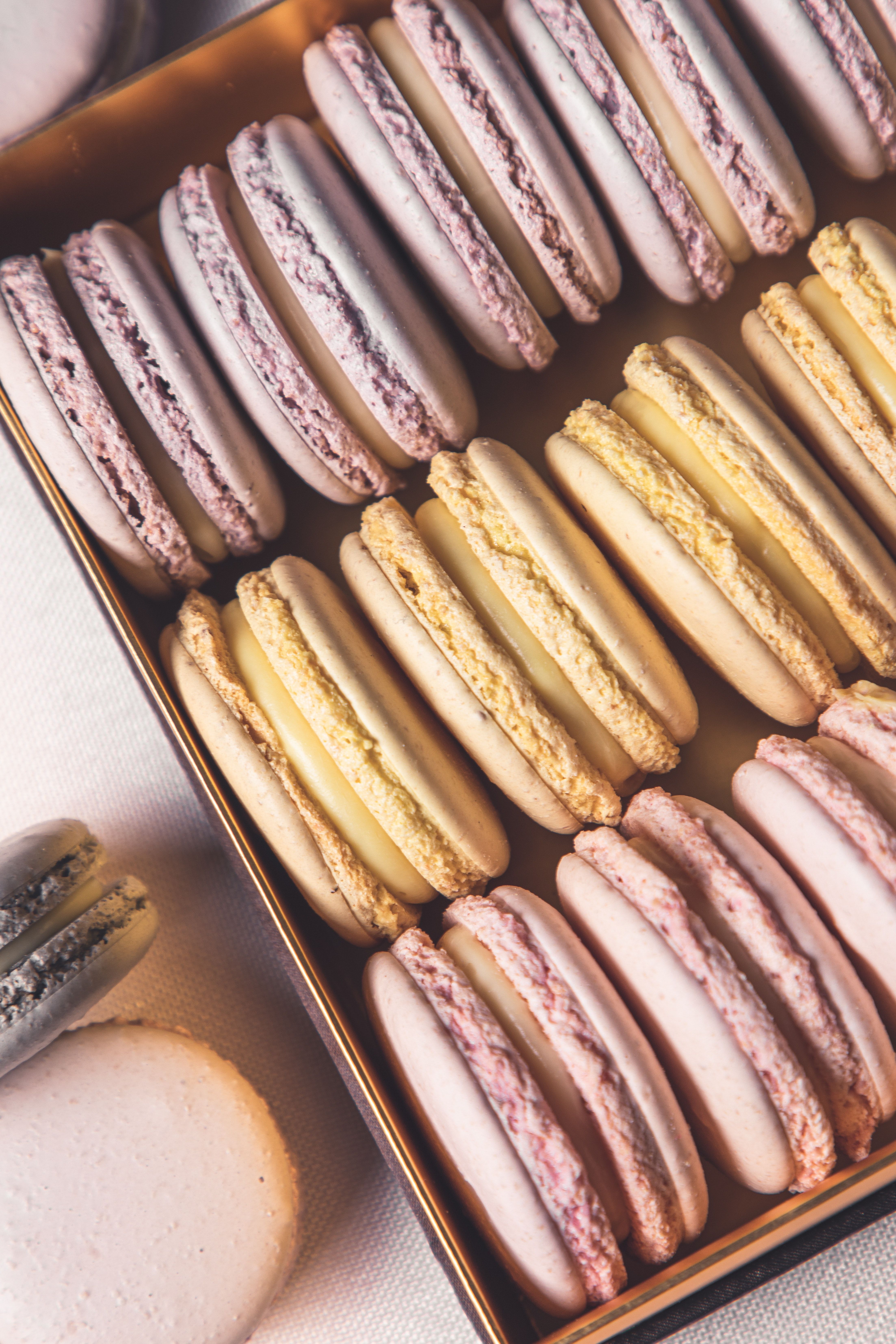A tray of pastries on top and bottom - Macarons