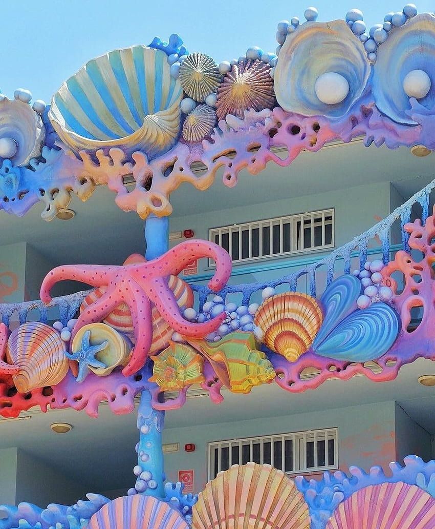 A colorful building with shells and sea creatures - Coquette