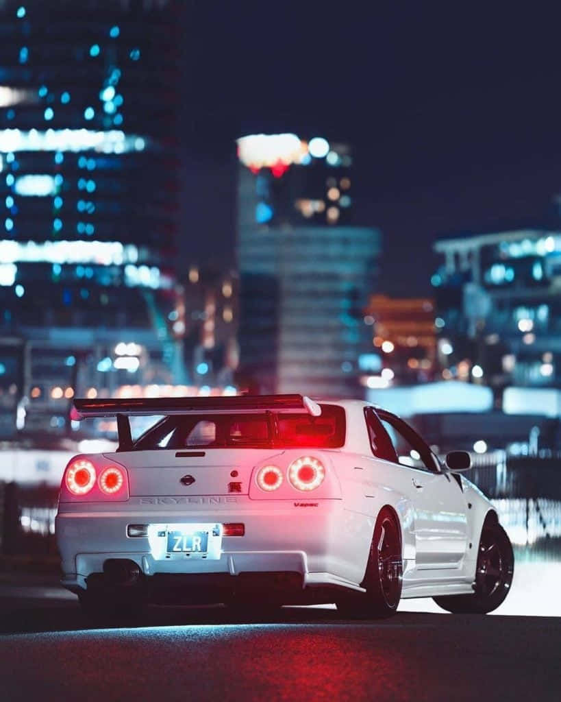 A white car with red lights on it - Nissan Skyline