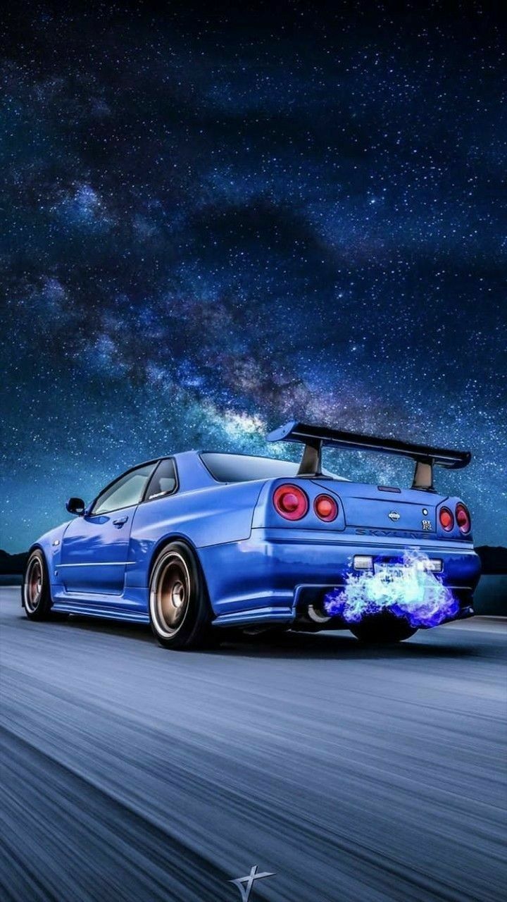 A blue sports car with flames on the back is driving down an empty road - Nissan Skyline