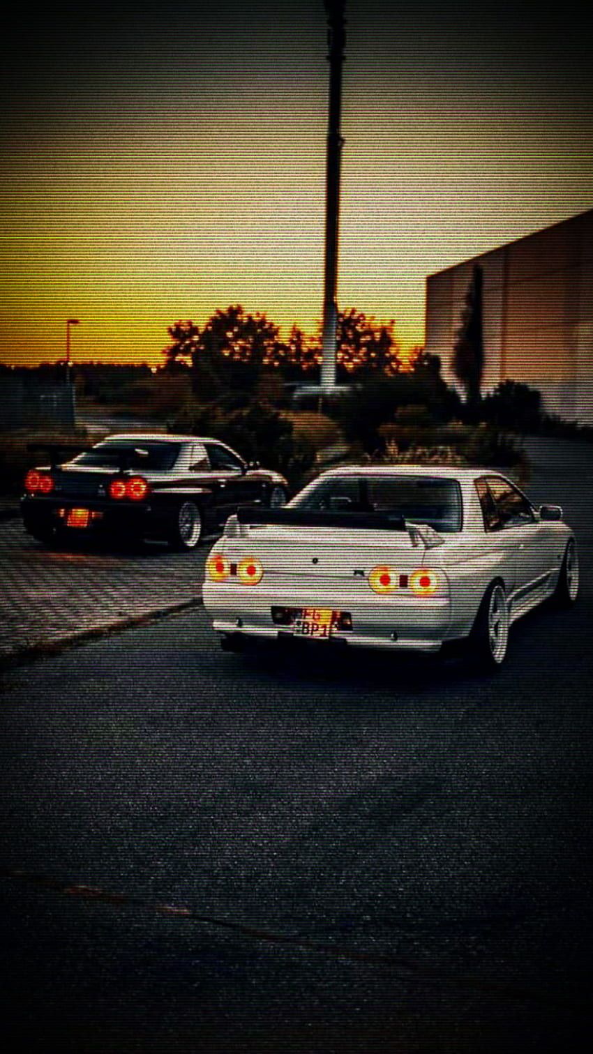 A car parked next to another one at night - Nissan Skyline
