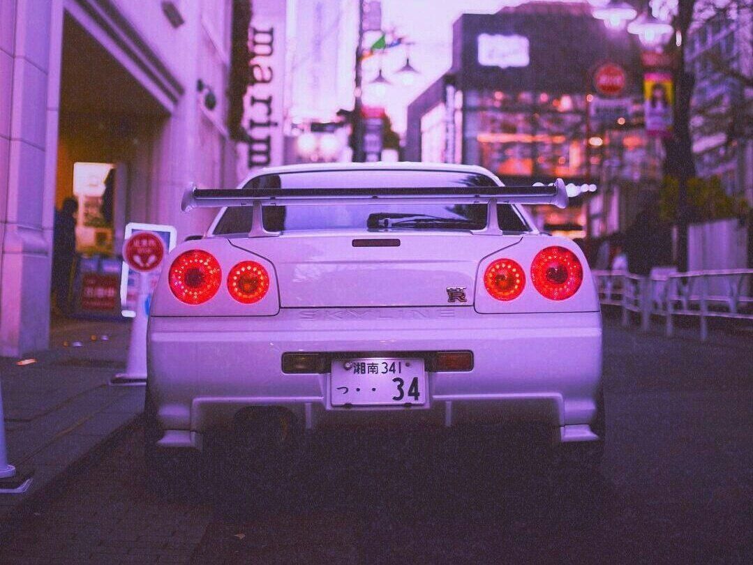 A purple car with the number 34 on the back of it - Nissan Skyline