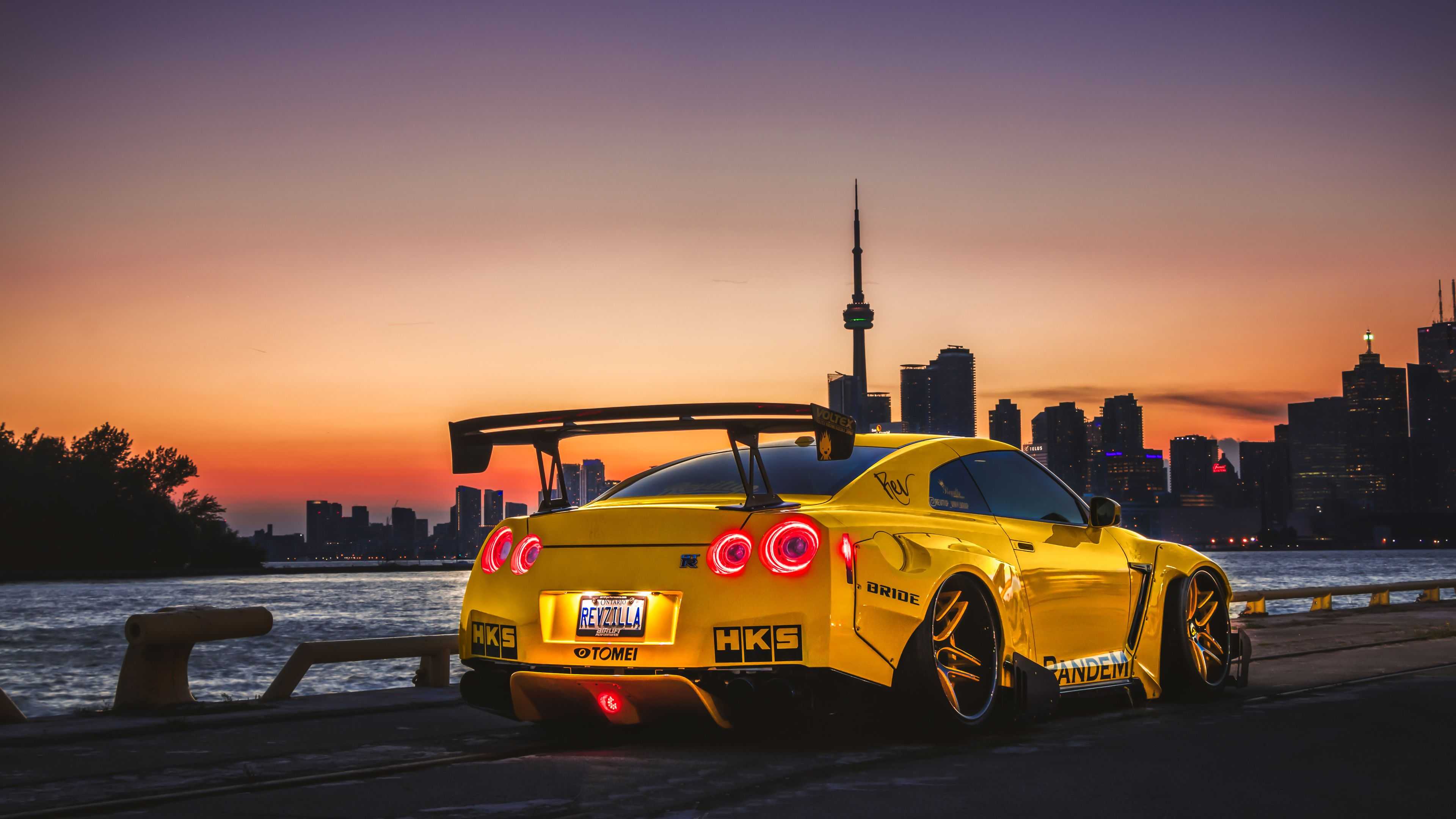 A yellow car parked on the side of the road - Nissan Skyline