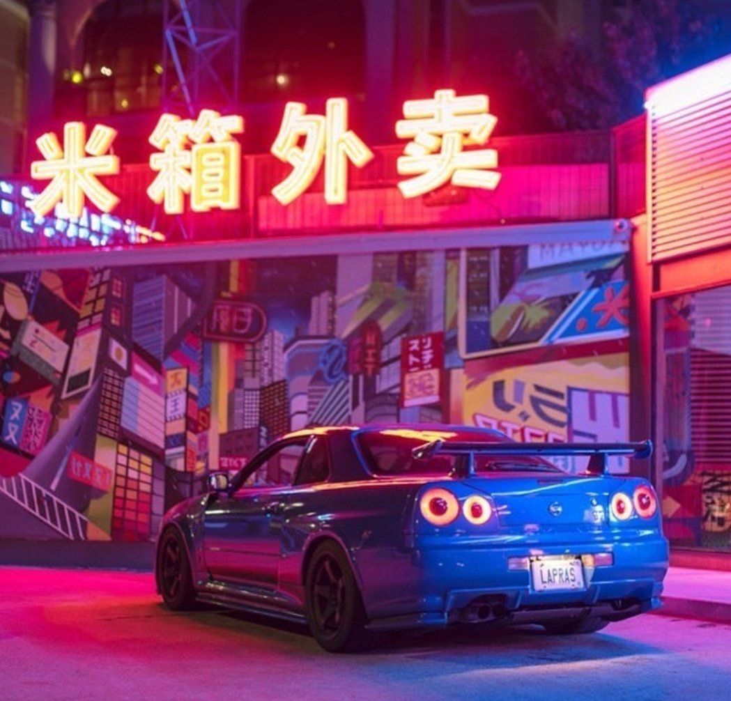 A car parked in front of a neon sign - Nissan Skyline