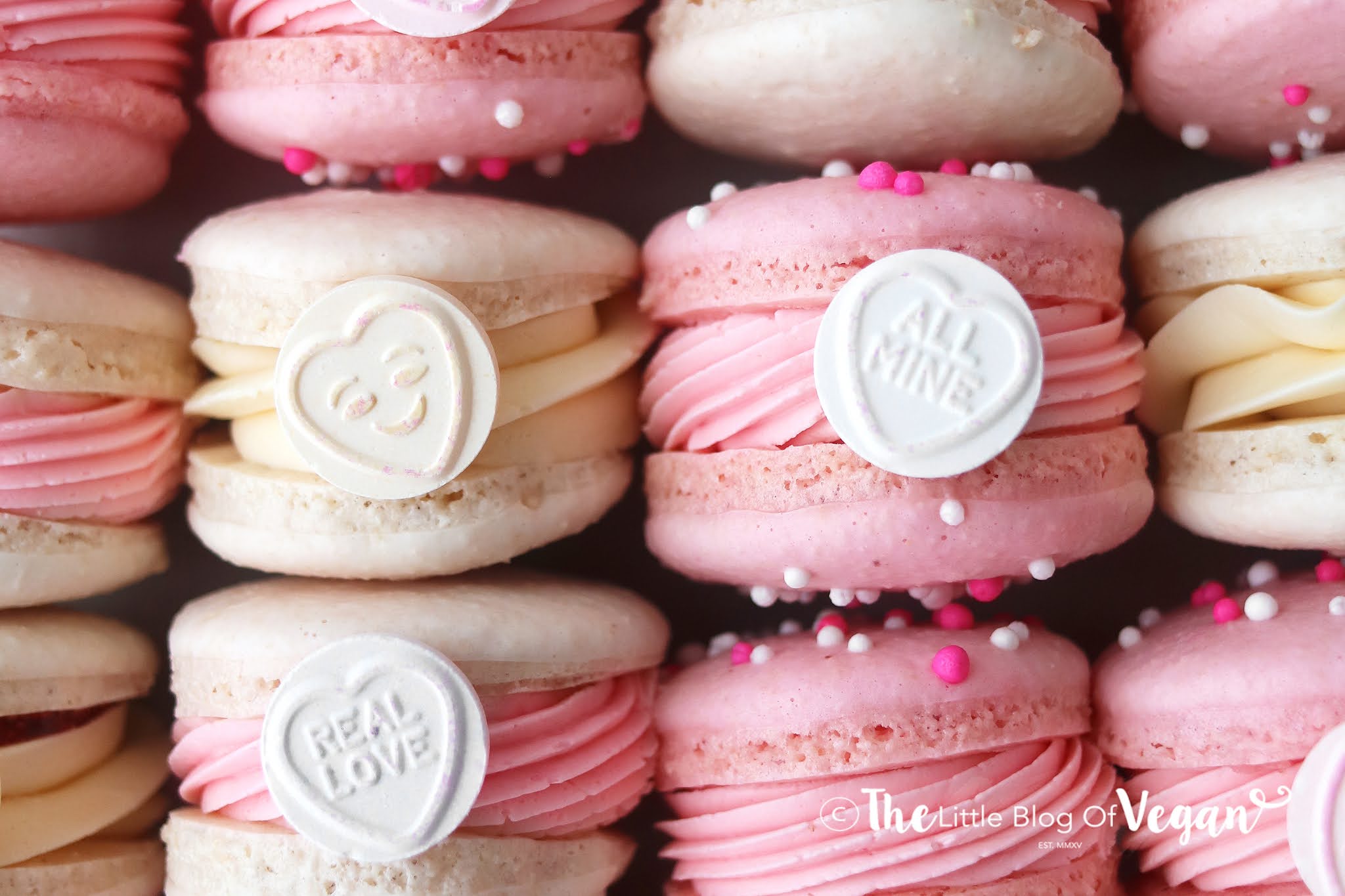 A close up of some pink and white macarons - Macarons