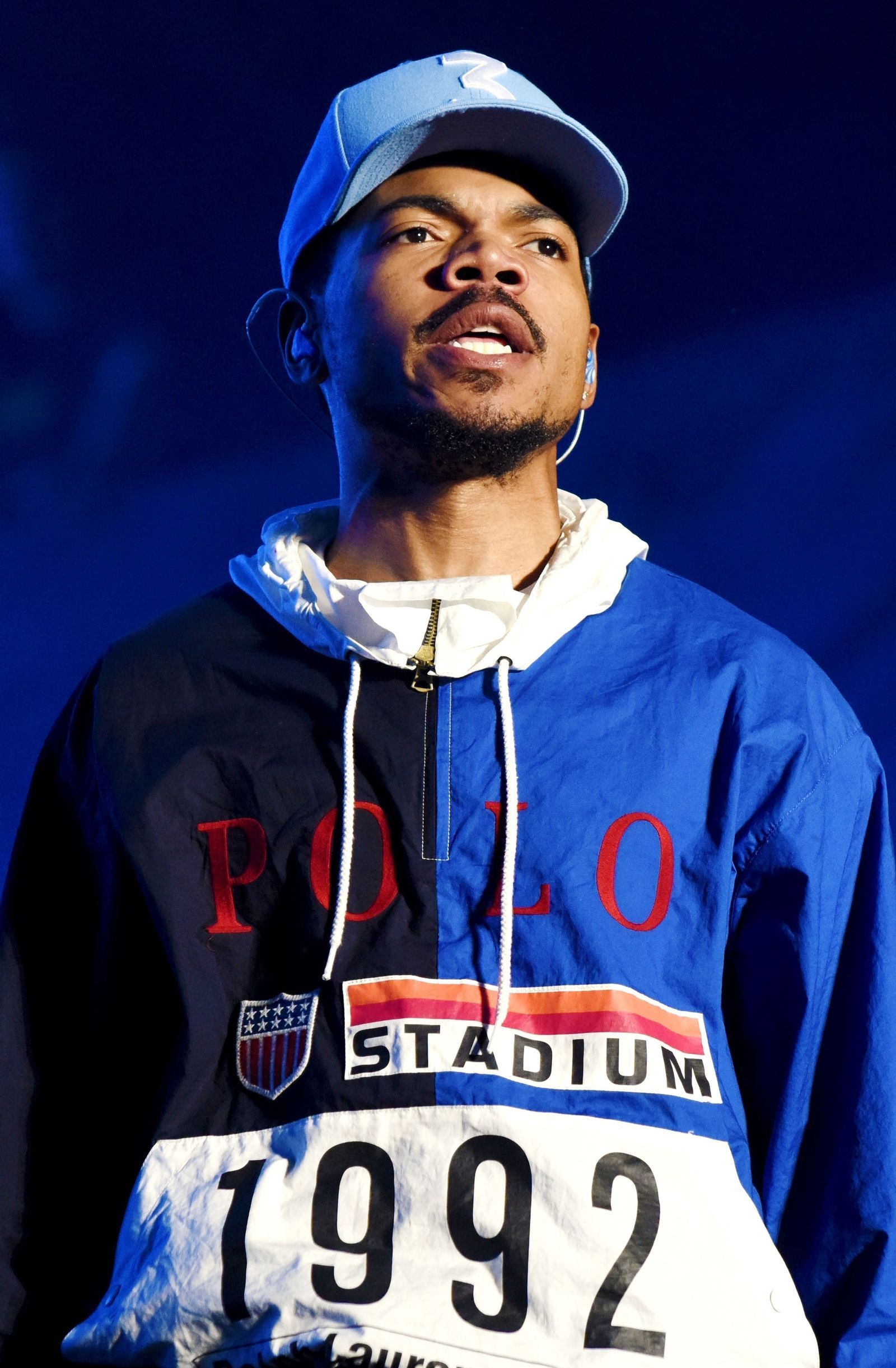 Chance the Rapper in a blue and white hoodie and blue baseball cap - Chance the Rapper