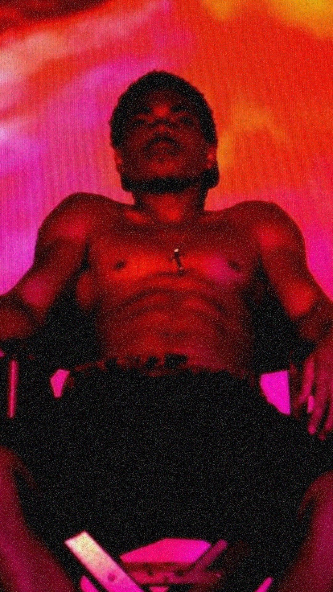 A man sitting in the chair with his shirt off - Chance the Rapper