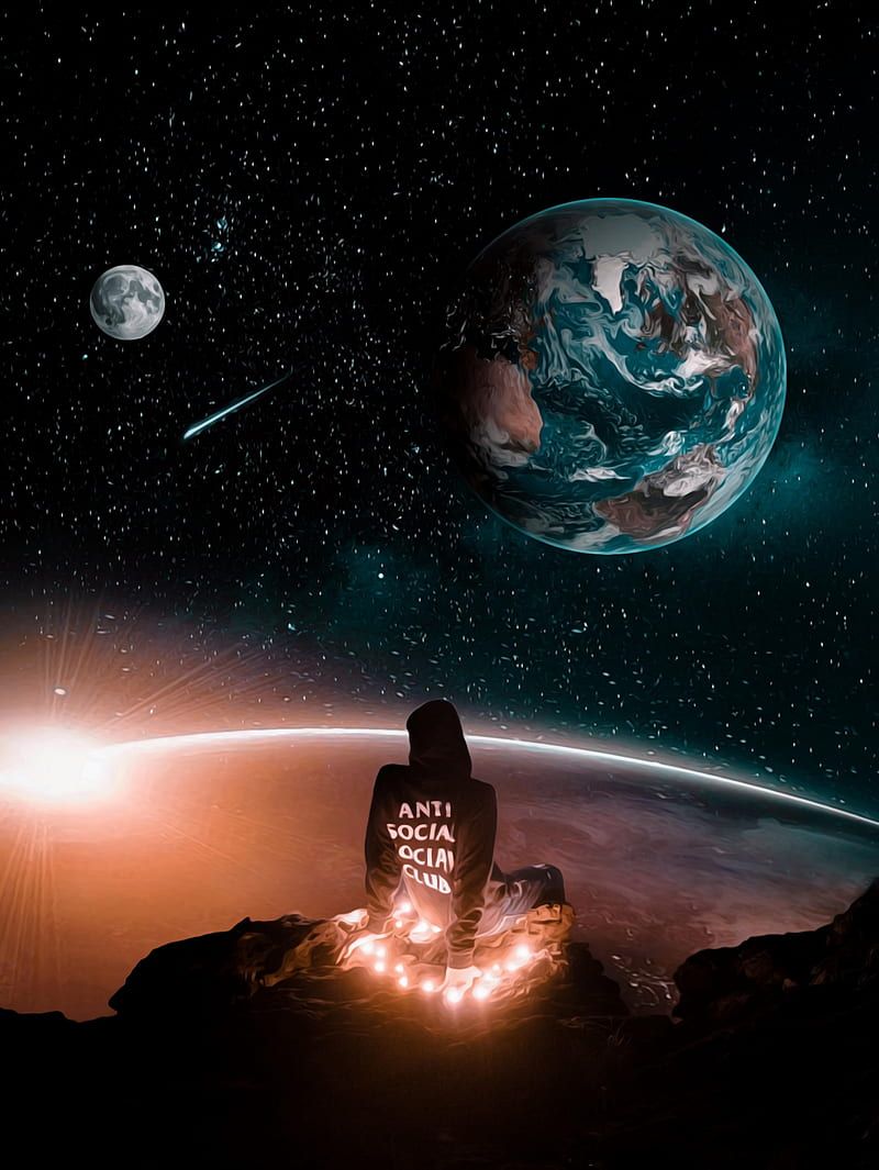 A person sitting on a planet with a hoodie that says 