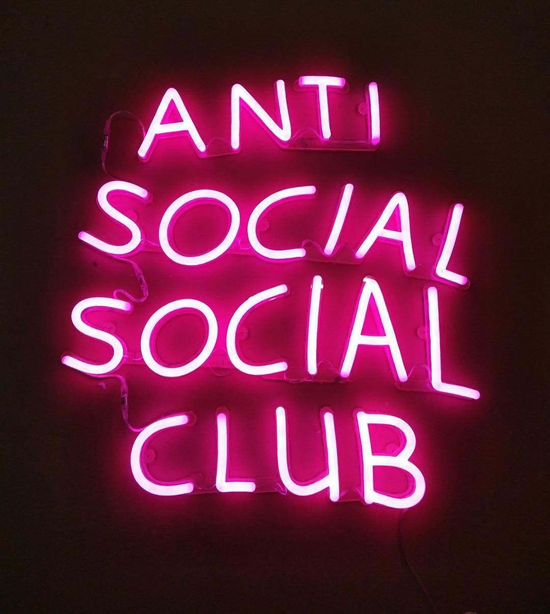 A neon sign that says anti social club - Anti Social Social Club