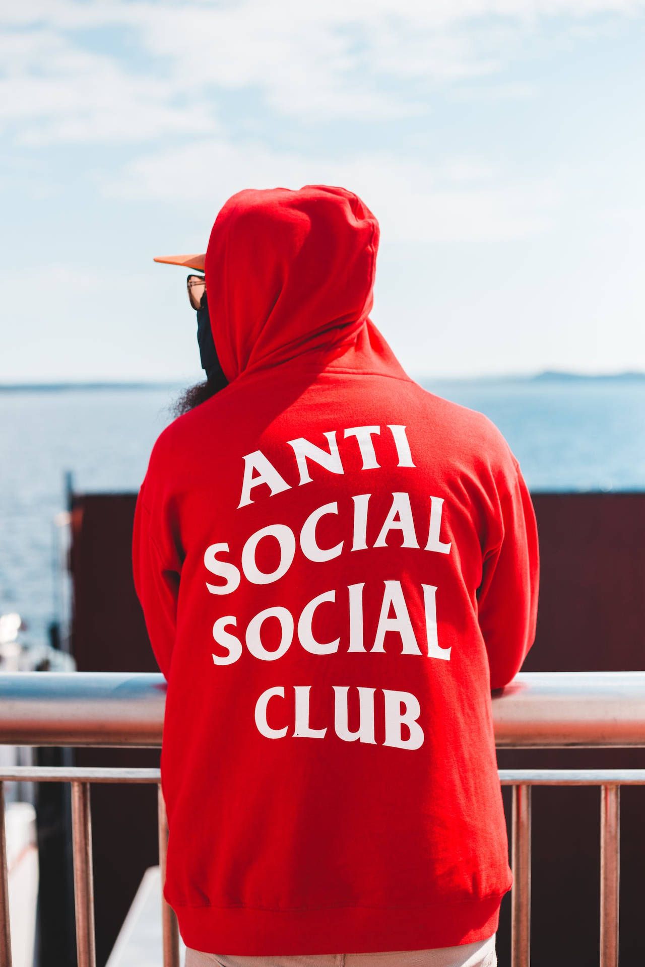 A man wearing an anti social club hoodie - Red, Anti Social Social Club