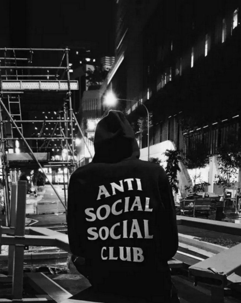 A person wearing a hoodie that says anti social social club - Anti Social Social Club