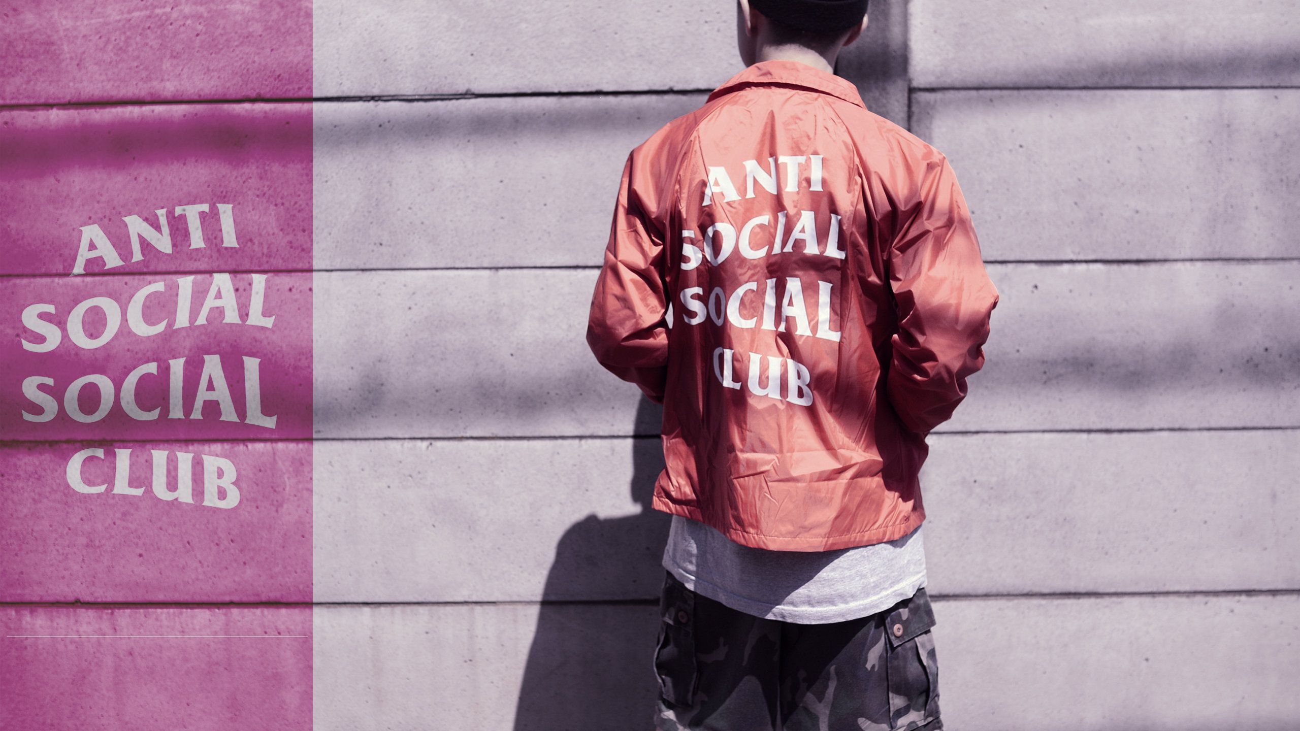 A man wearing an orange shirt with the words anti social club on it - Anti Social Social Club