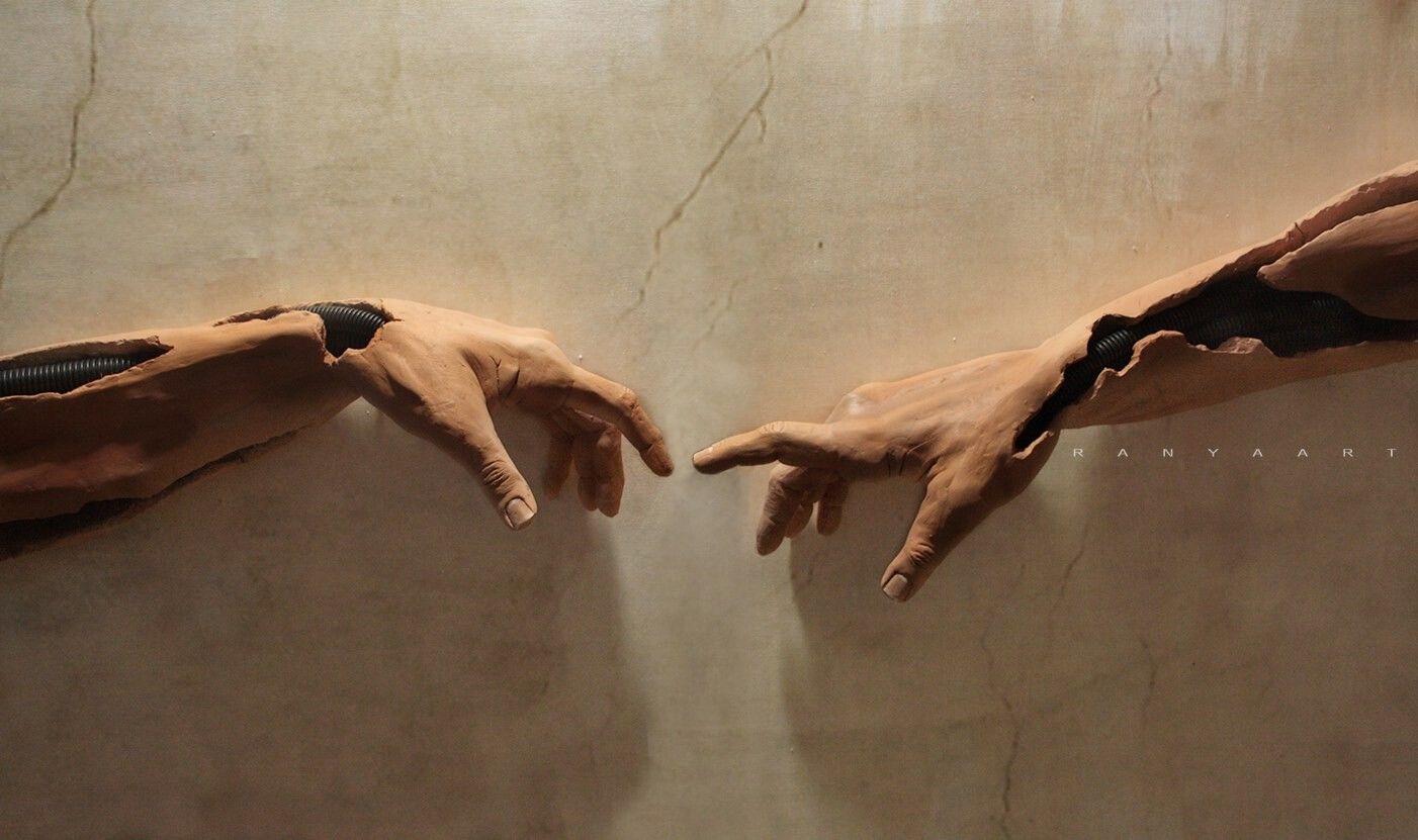A sculpture of two hands reaching out to each other - The Creation of Adam