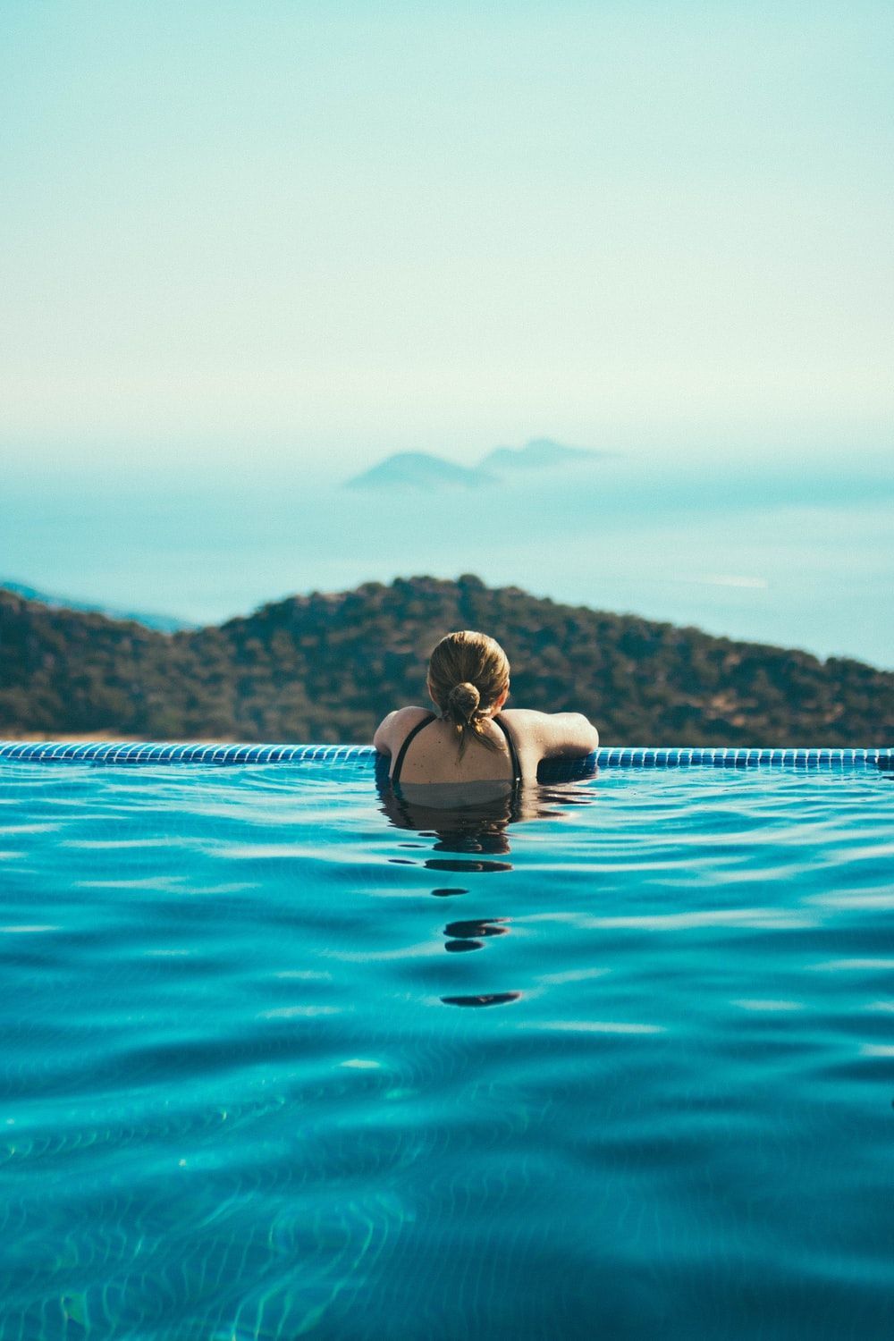 A woman is floating in the pool - Swimming pool