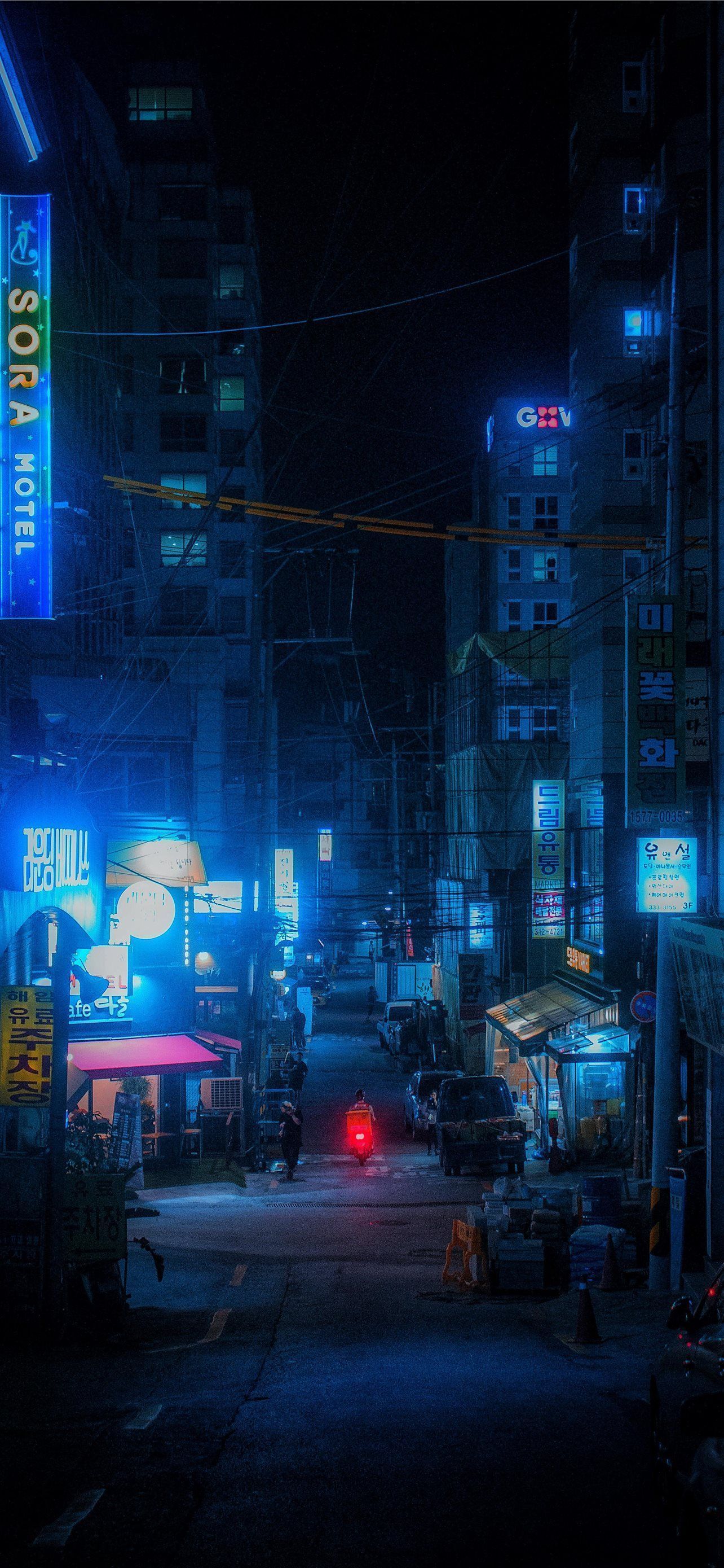 Aesthetic wallpaper of a neon lit city street at night - Seoul