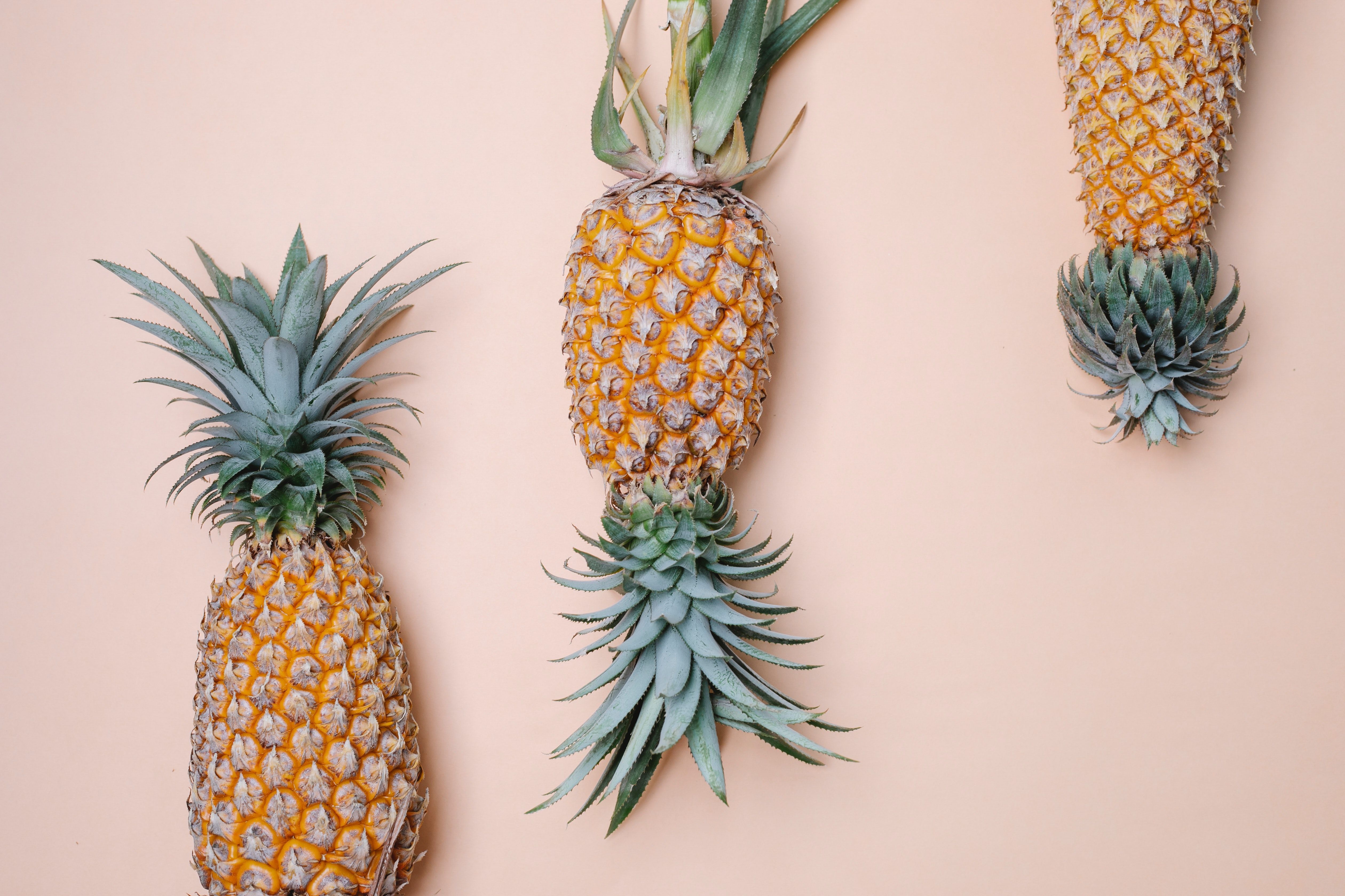 Three pineapples on a pink background - Pineapple