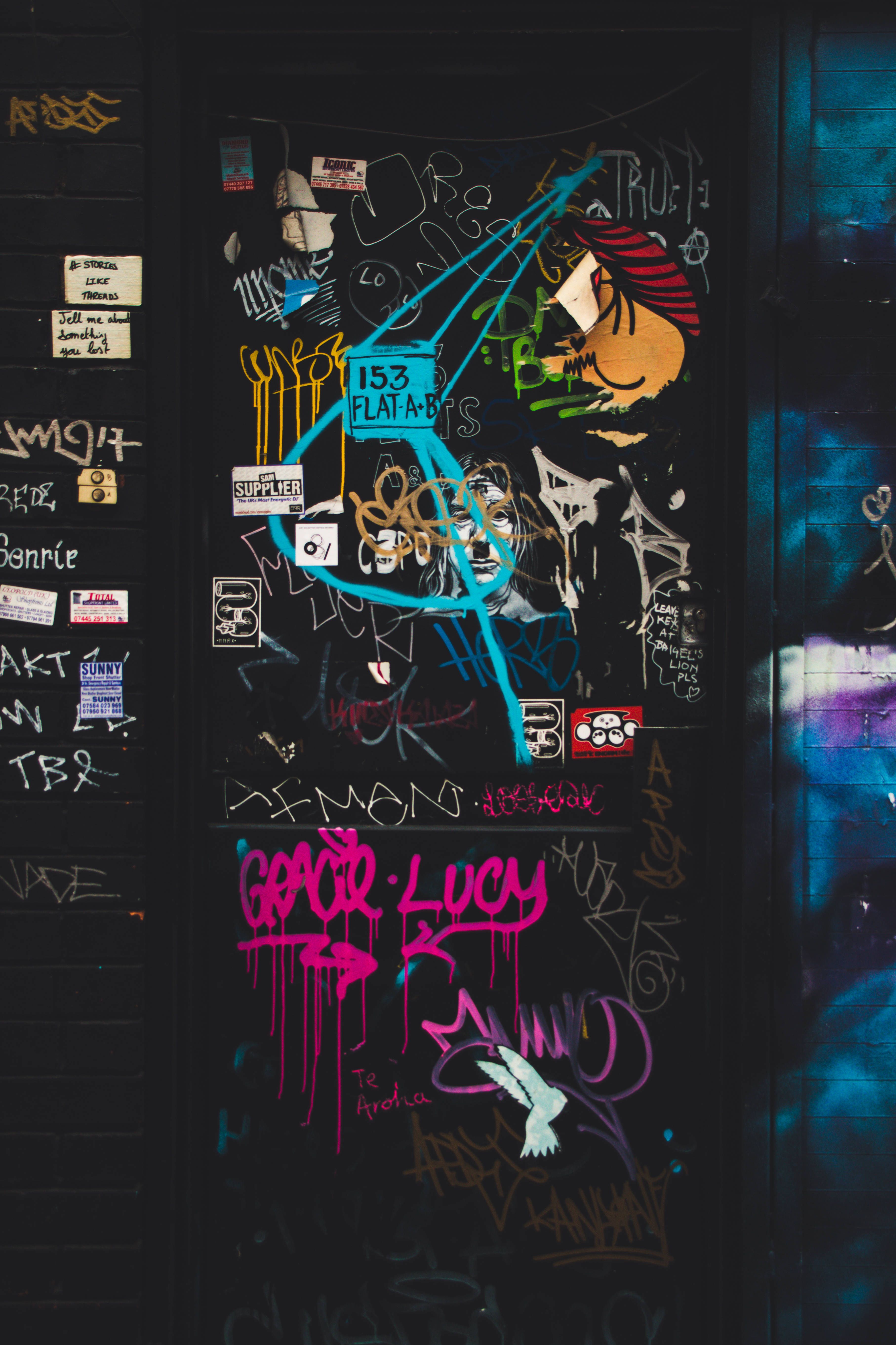 A door with graffiti on it and some stickers - Street art, graffiti