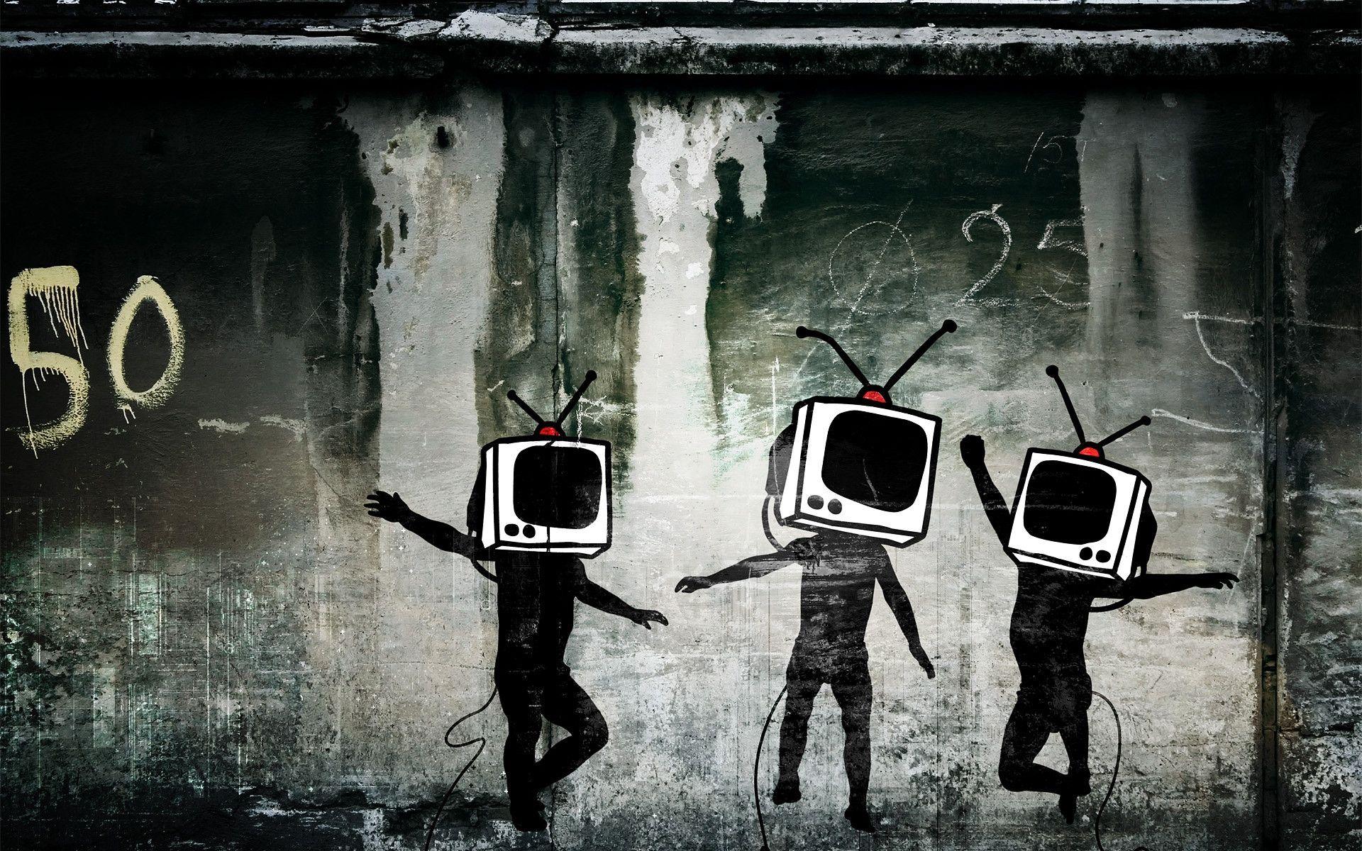 Graffiti of three people with television sets for heads dancing in front of a wall. - Street art, graffiti