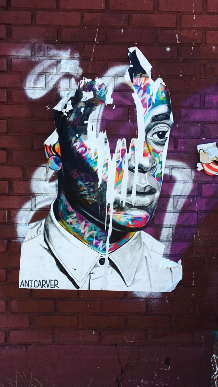 A graffiti of a man with a white collar shirt and a tie. - Street art