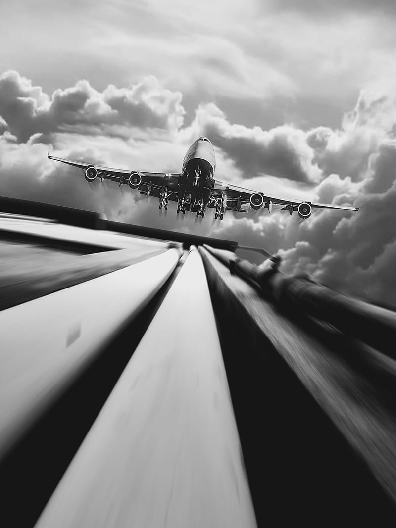 An airplane flying over a highway with motion blur. - Airplane