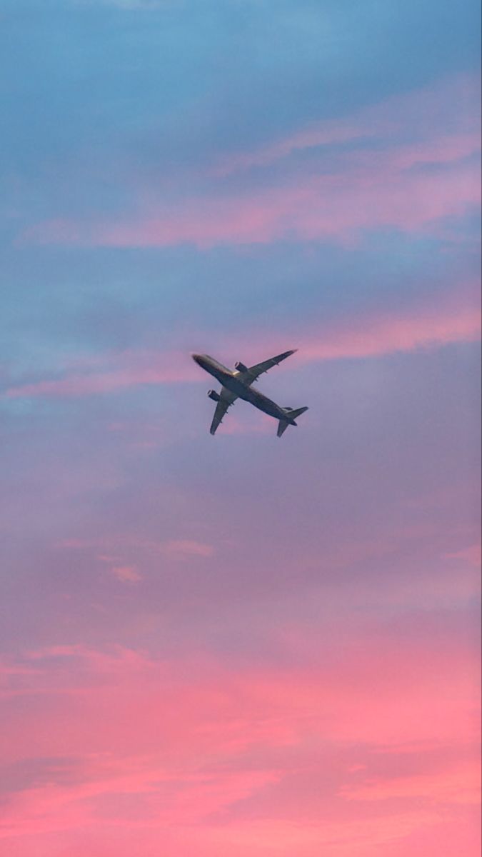 An airplane flying in the sky during sunset - Airplane