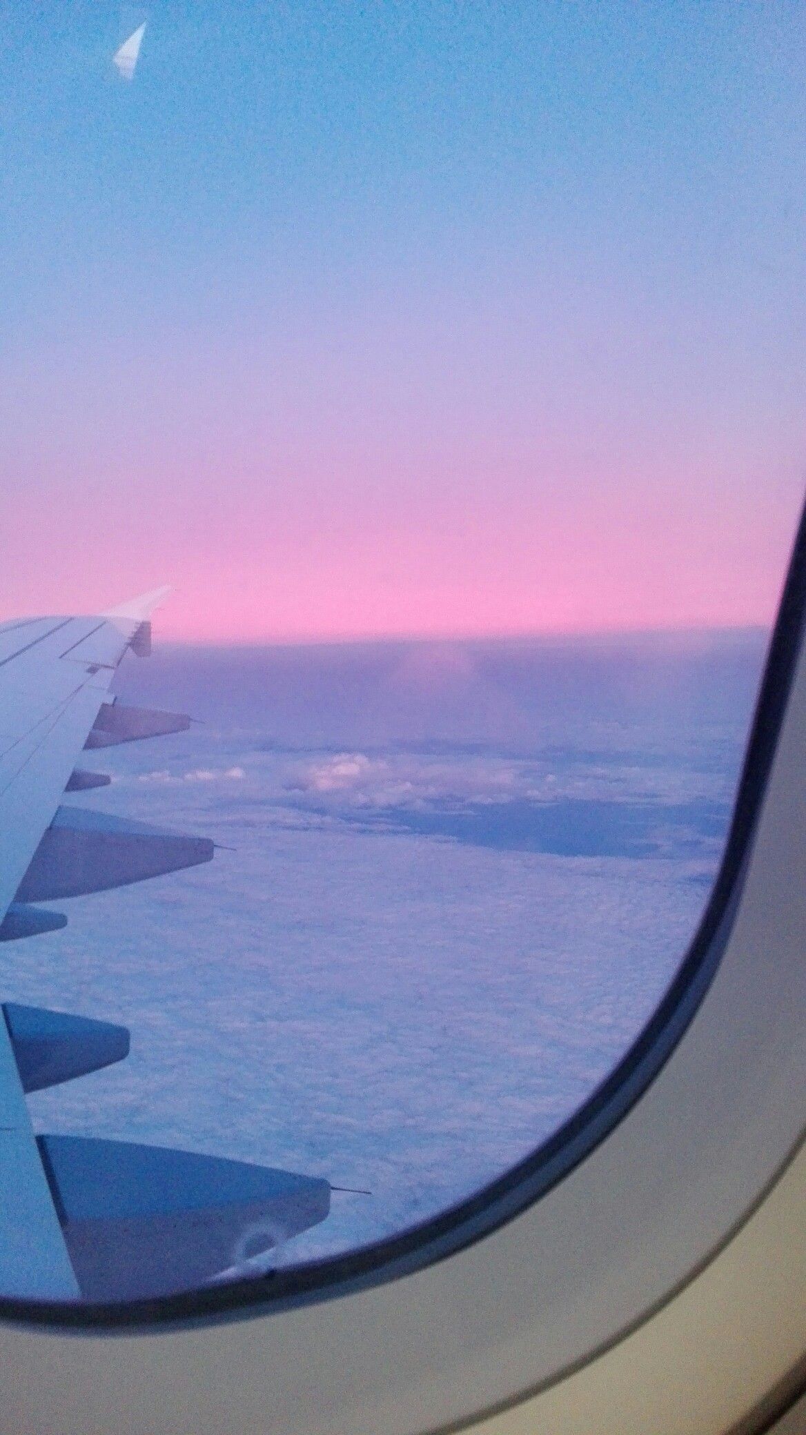 A view of the sky from an airplane window. - Airplane