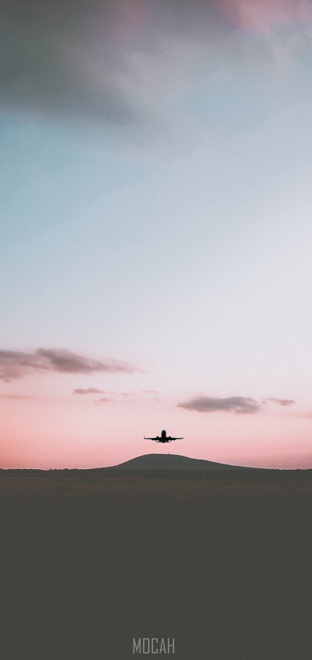 A plane flying over an empty field - Airplane