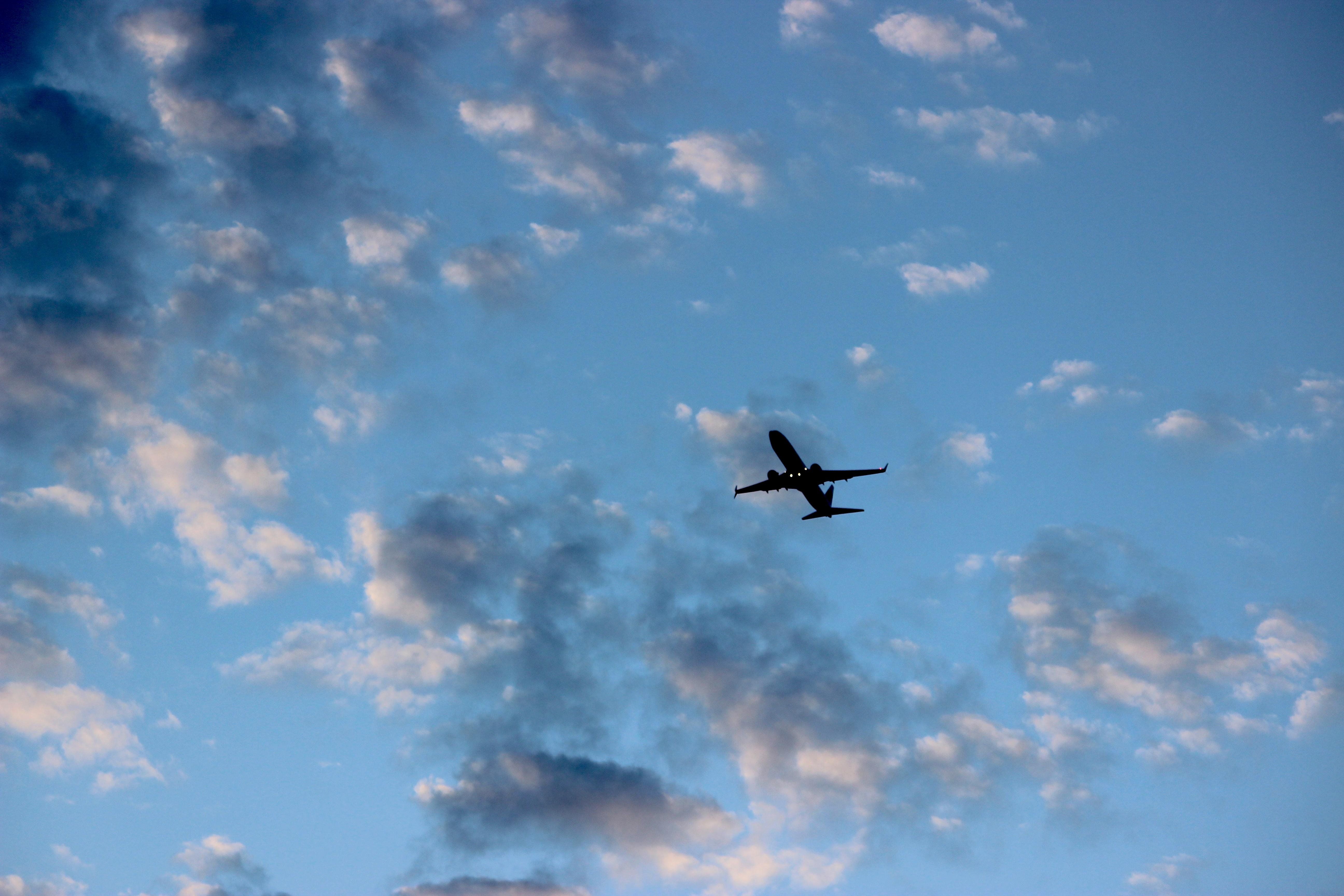 A plane flying through the sky on its way to land - Airplane