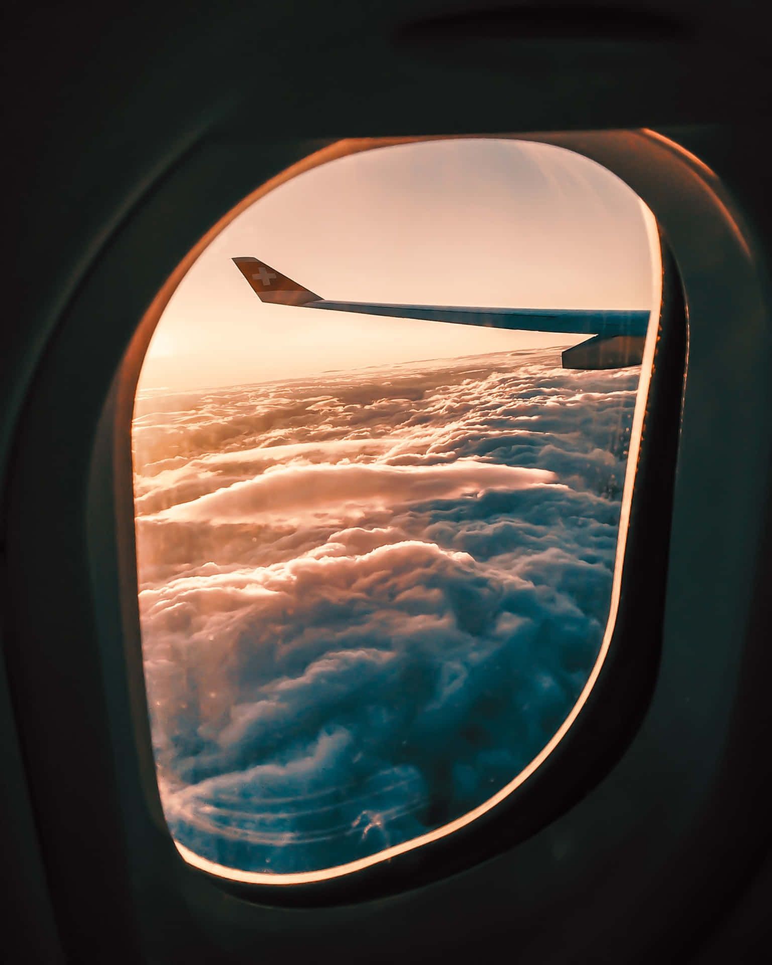 A window of an airplane showing the clouds - Airplane