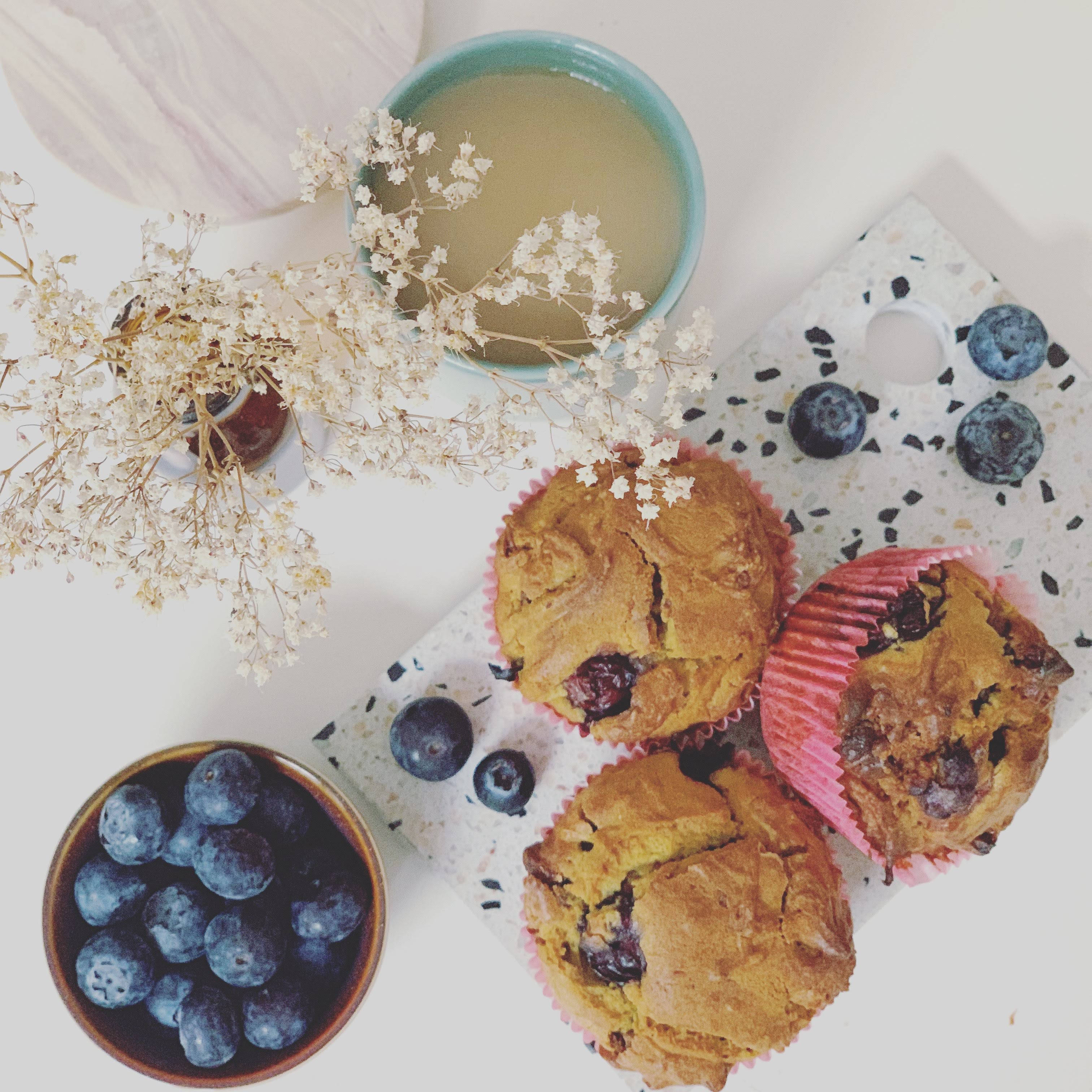 A table with muffins and blueberries on it - 