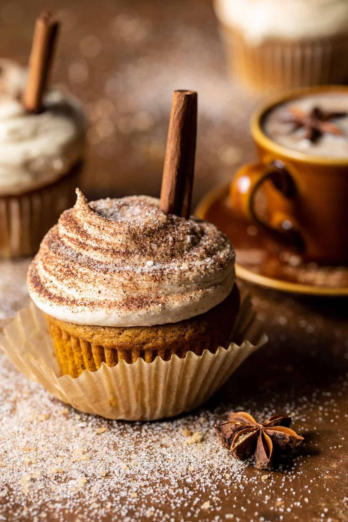 A close up of a spiced cupcake with a cinnamon stick in it. - 