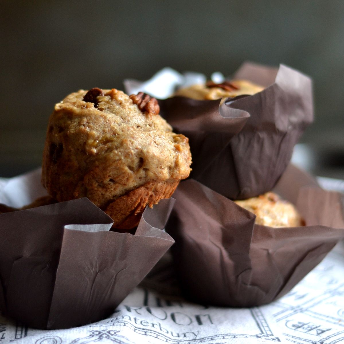 A muffin is sitting on top of some paper - 