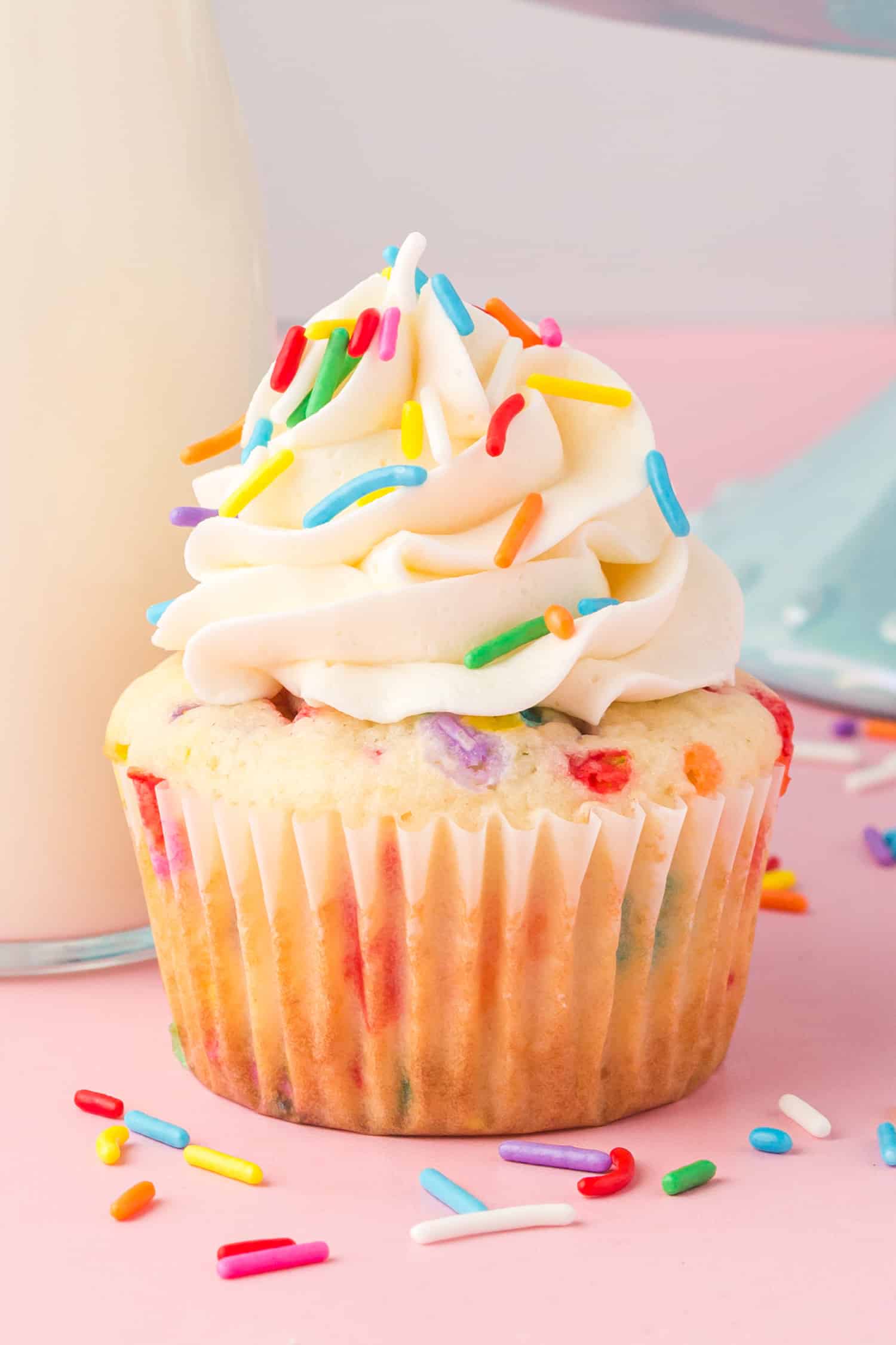 A cupcake with sprinkles and frosting - 